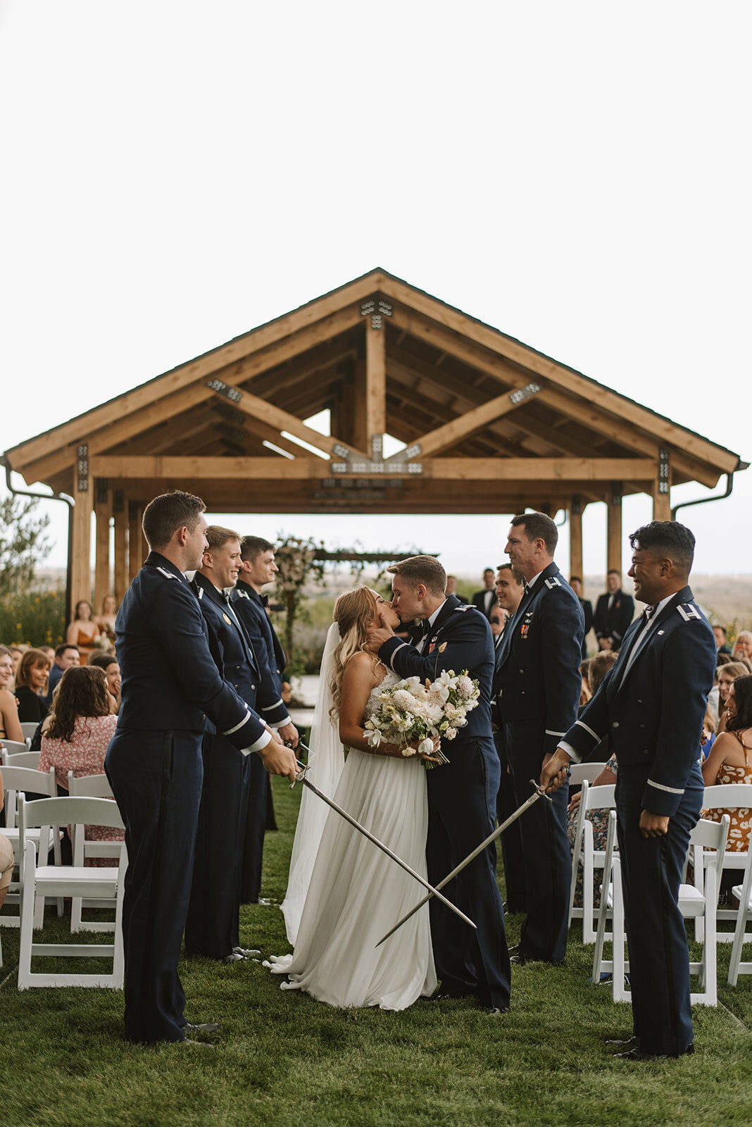 Bride and groom kissing on their wedding ceremony