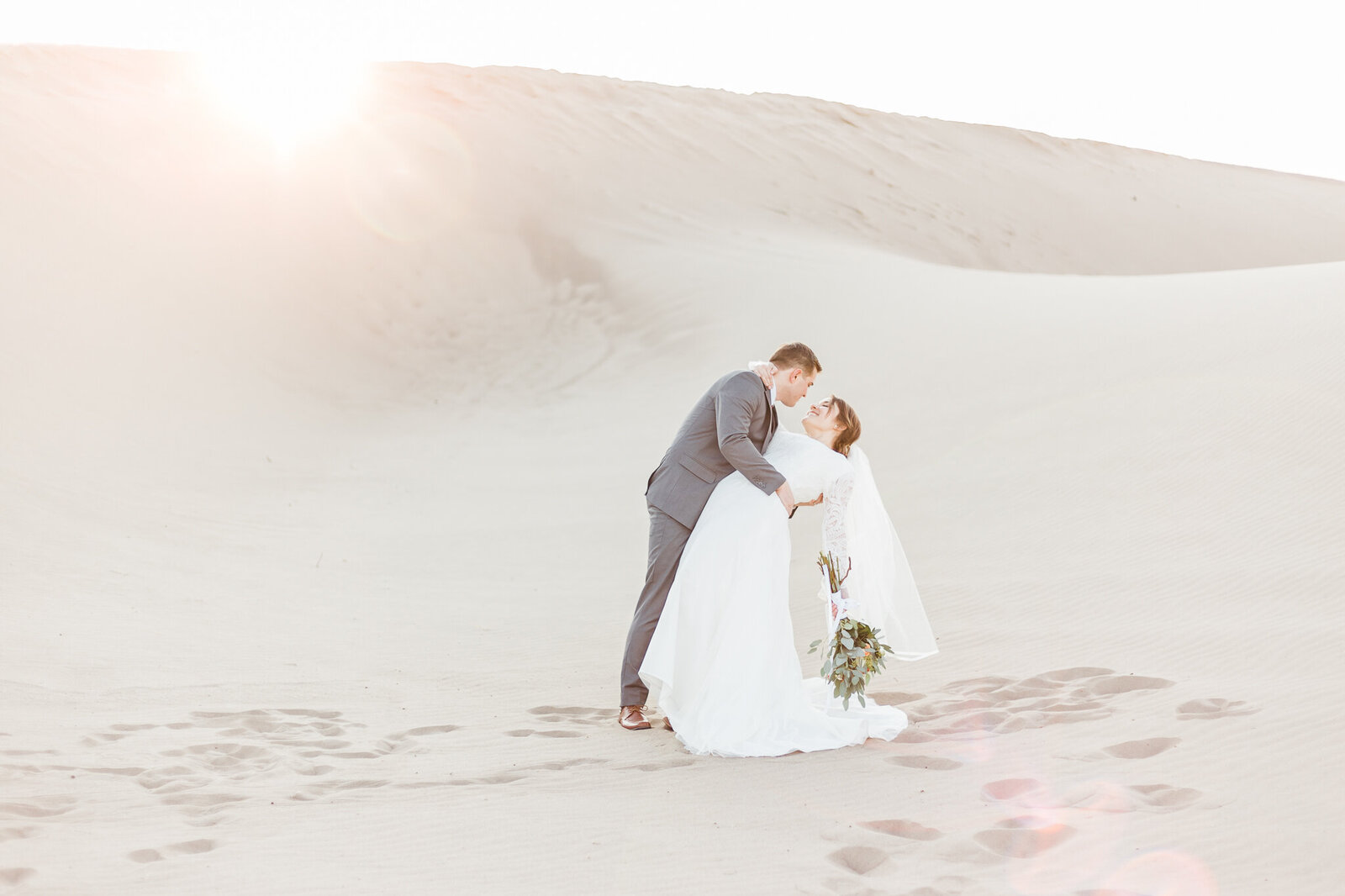 bride and groom wedding photos in sand