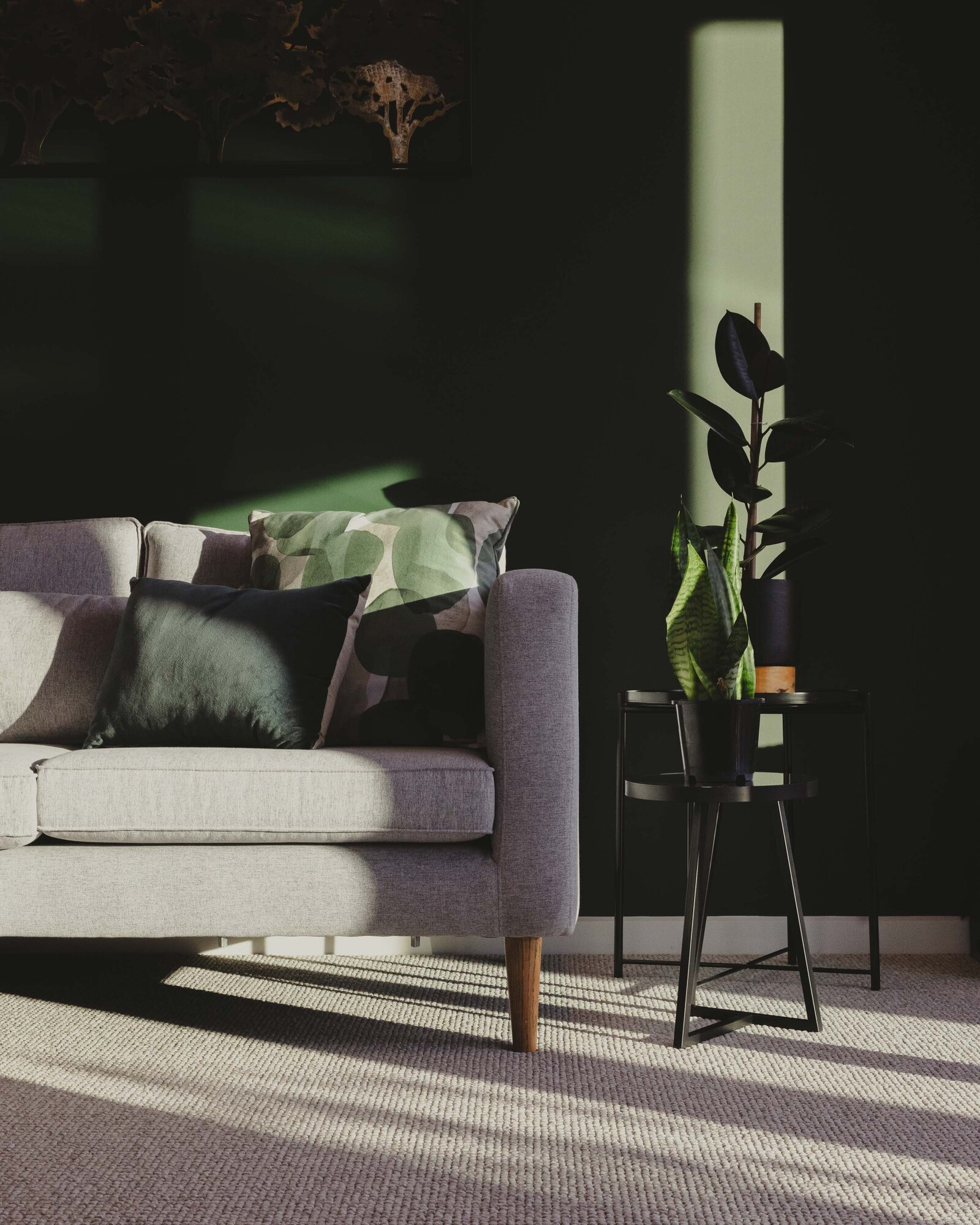 A beautiful lounge with green feature wall in a home built by Twin Peaks Construction Queenstown.