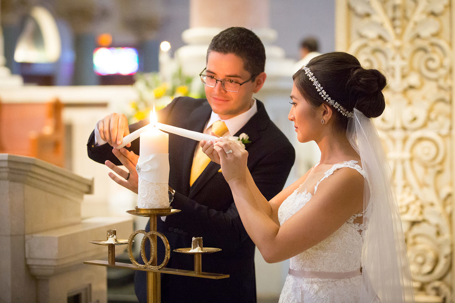 couple lighting candles at the immaculata