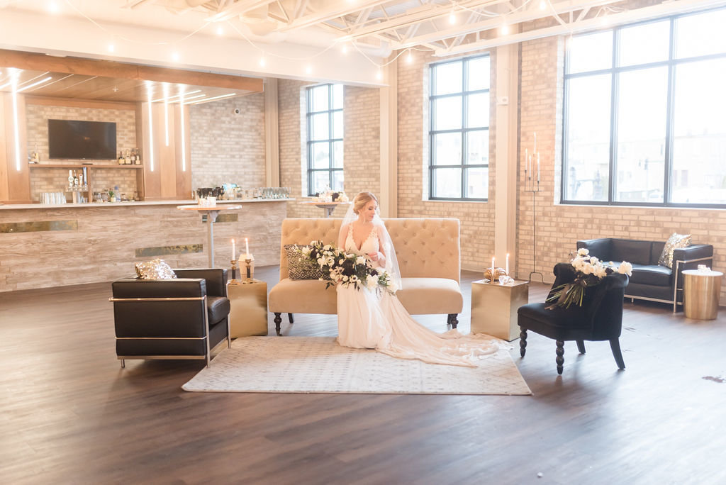 bride sitting on a couch in wedding venue