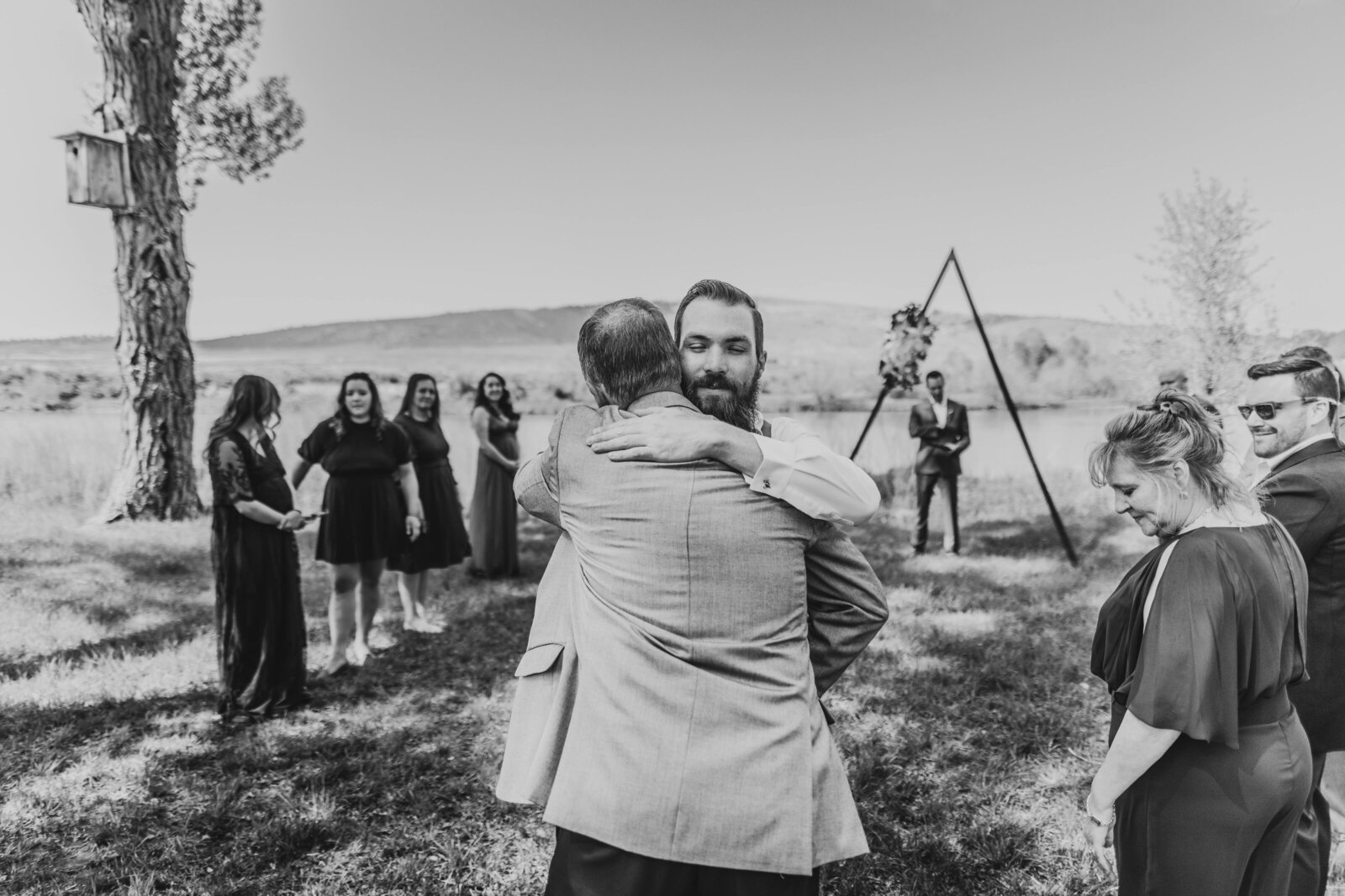 groom hugging dad at alter