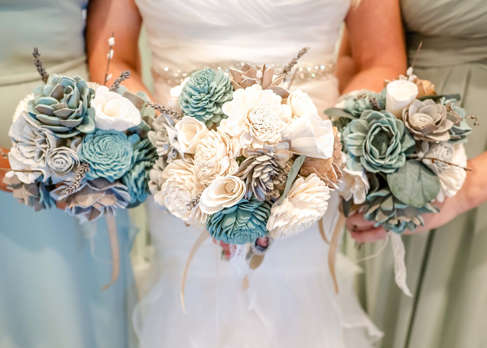 Stunning bridal bouquets featuring intricate paper flowers in shades of teal and cream, beautifully arranged for a Wilmington, NC wedding.