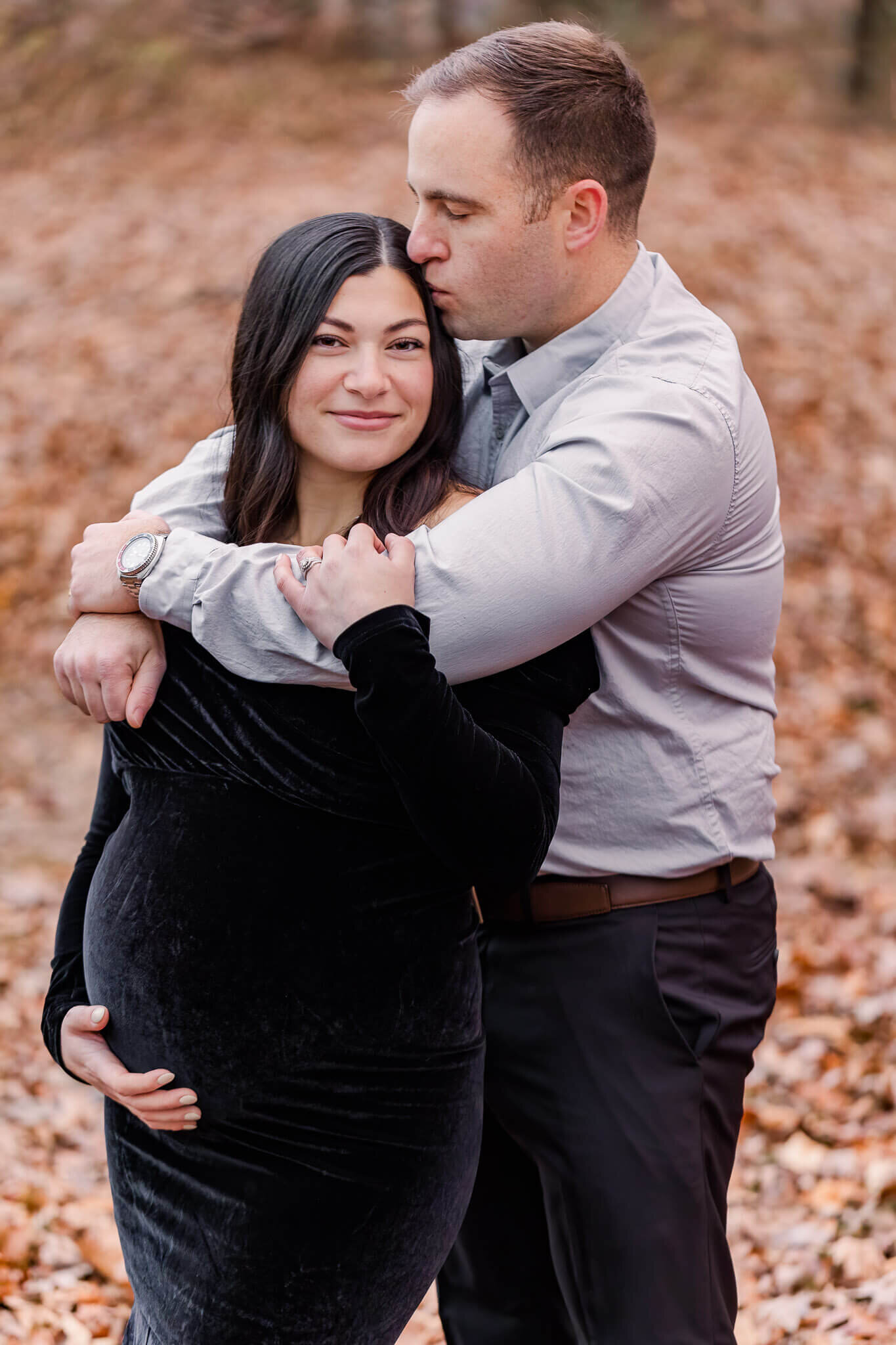 An expecting couple embracing during their maternity portraits.