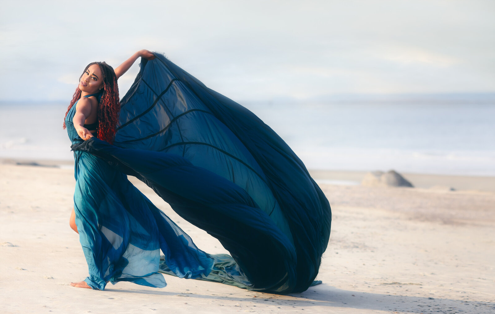 Savannah Georgia Boudoir and Glamour Woman in blue parachute gown on beach flowing like a butterfly