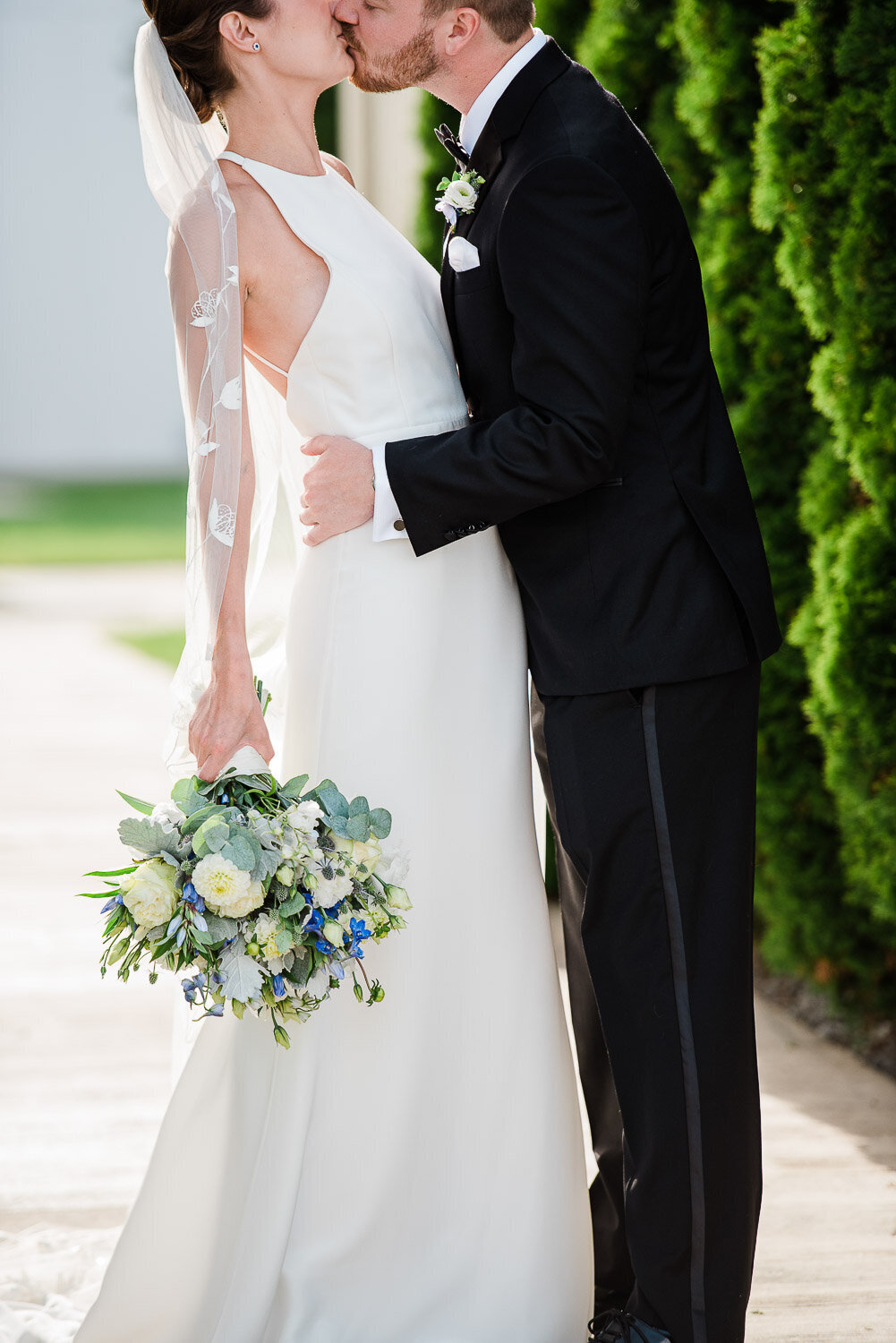 anonymous embrace and kiss bride and groom