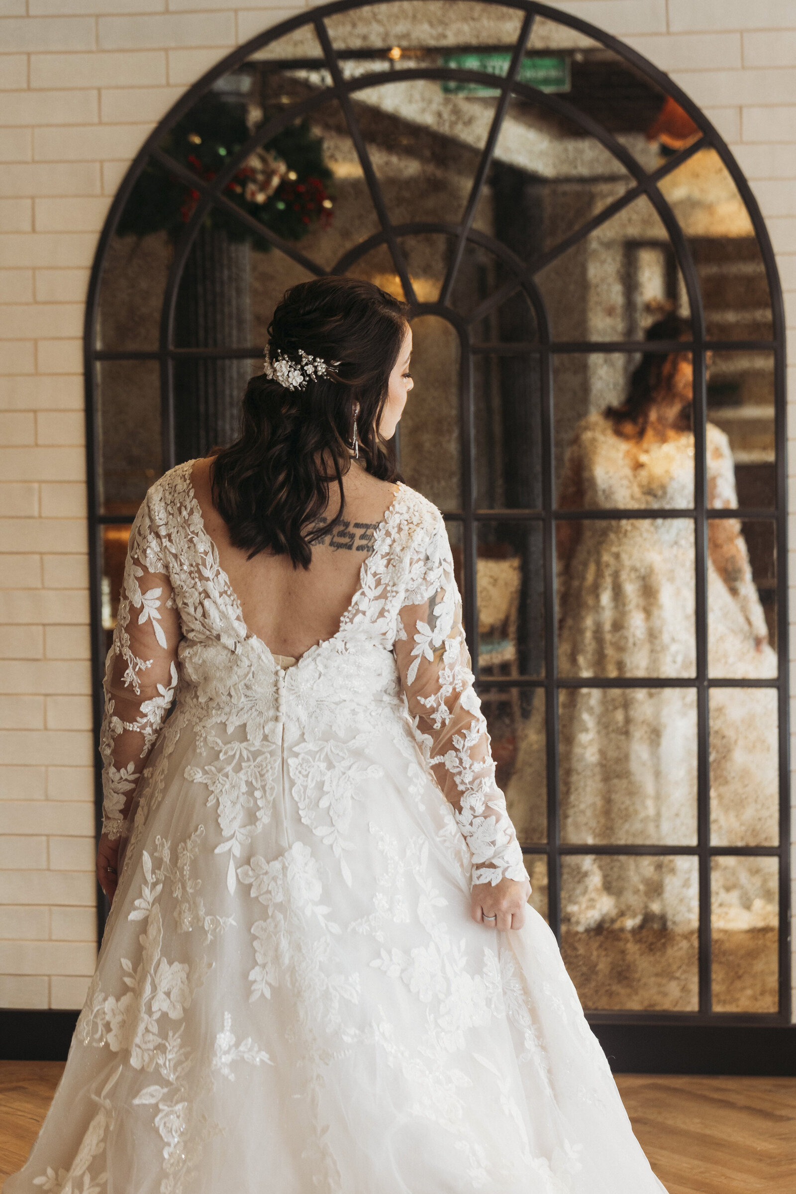 Back of brides dress with reflection in arched mirror on the Disney Wish