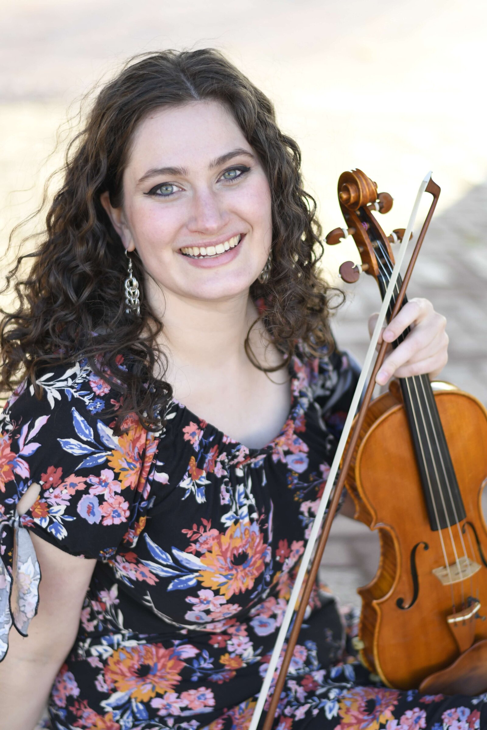 Seattle violin teacher Erika Burns siting down with her violin.