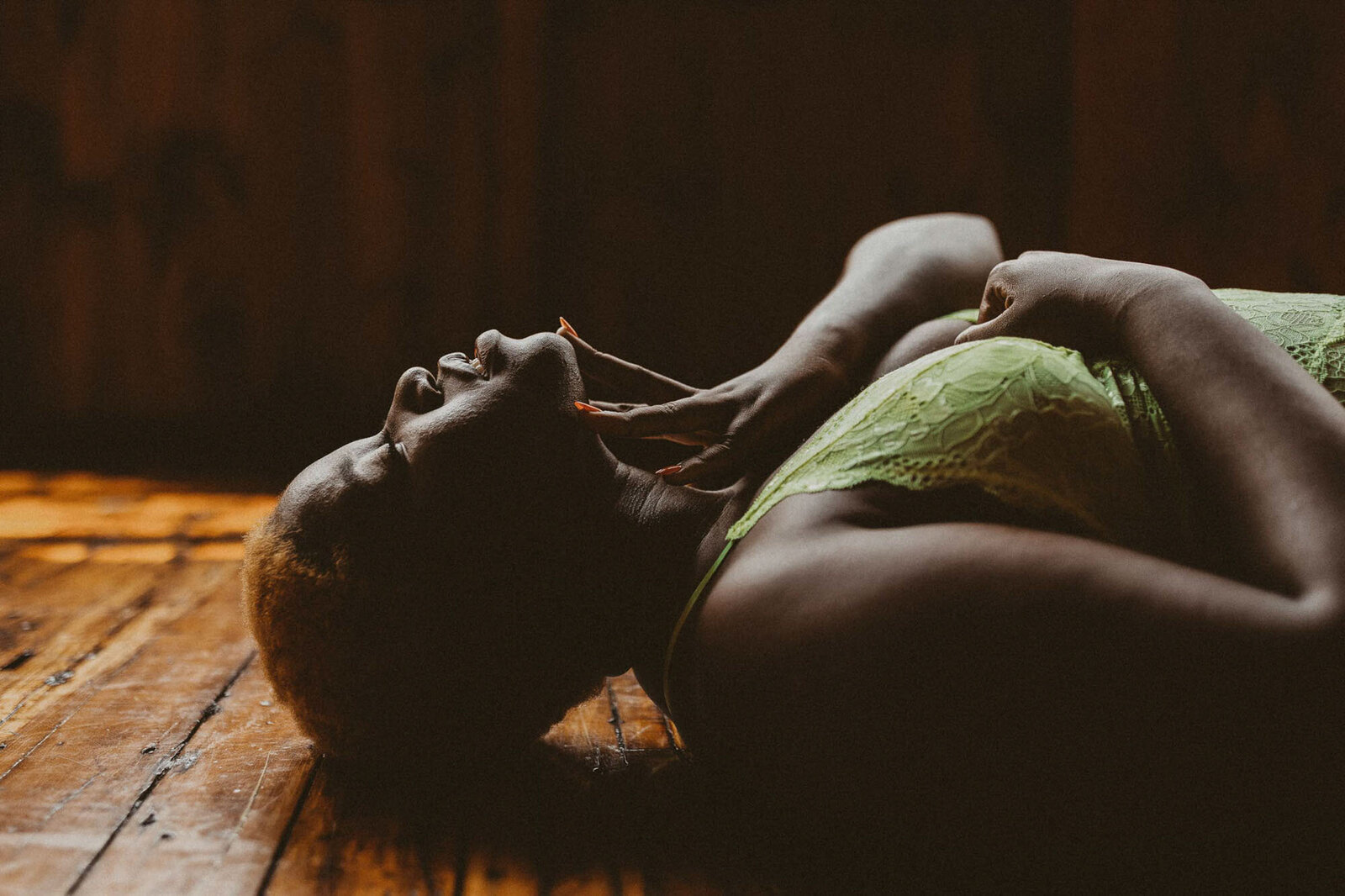 woman in a green bra laying down on the floor