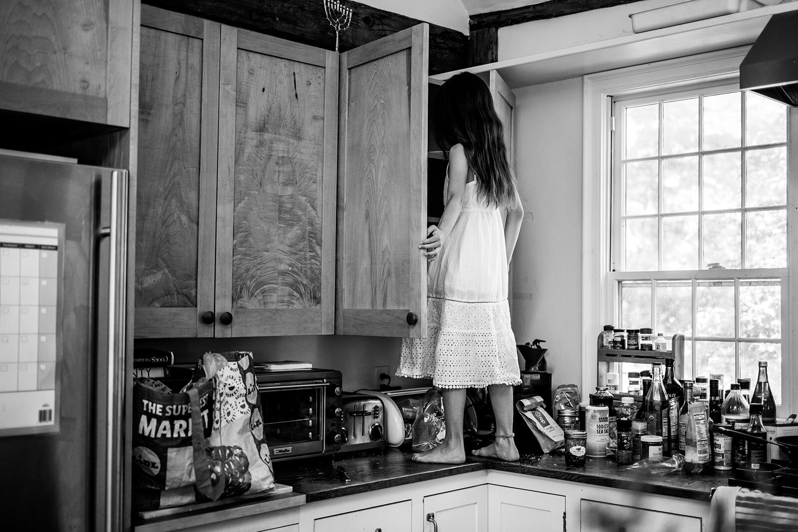 child-climbing-kitchen-counter-real-life-family-photo