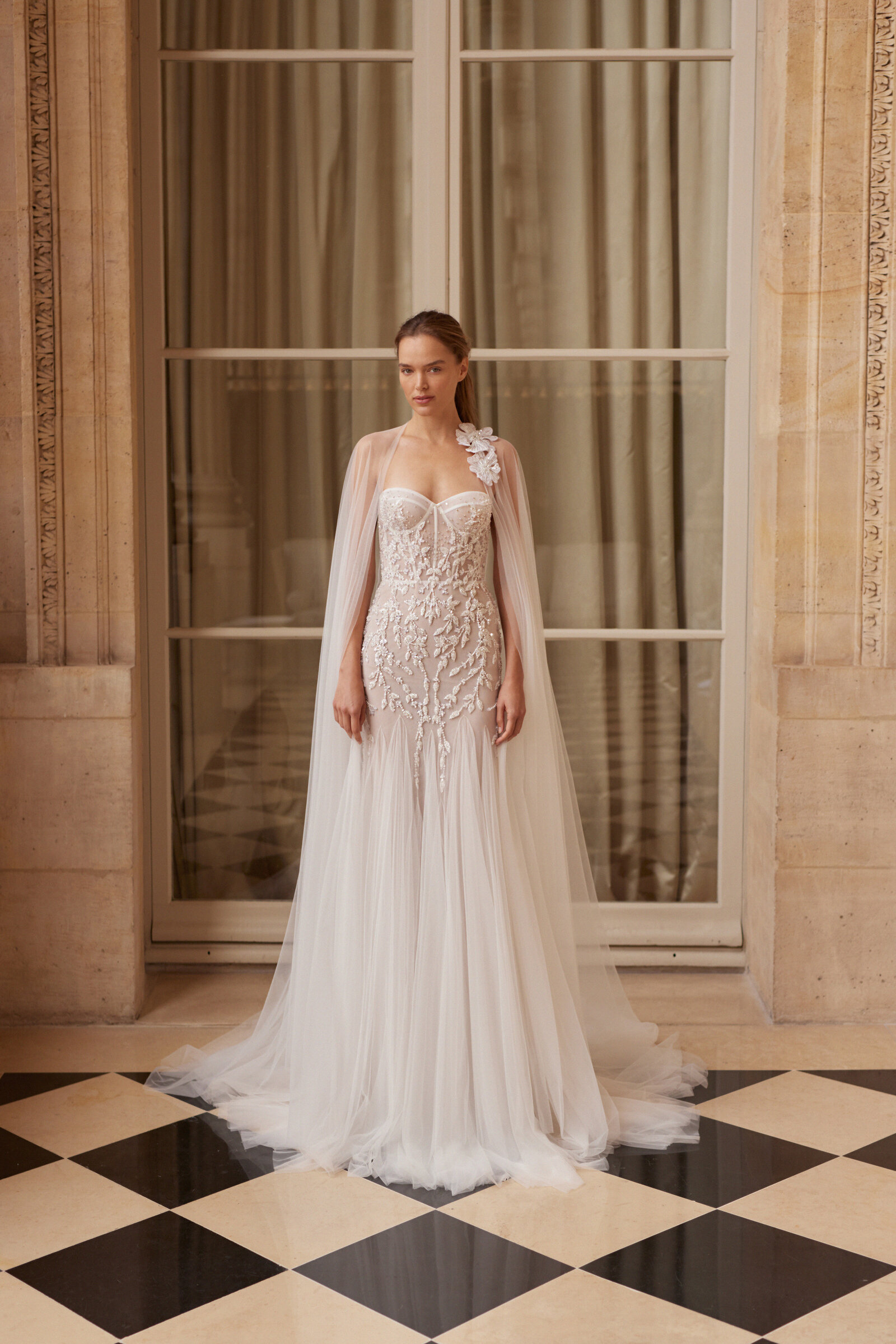bride wearing strapless lace wedding dress with tulle cloak