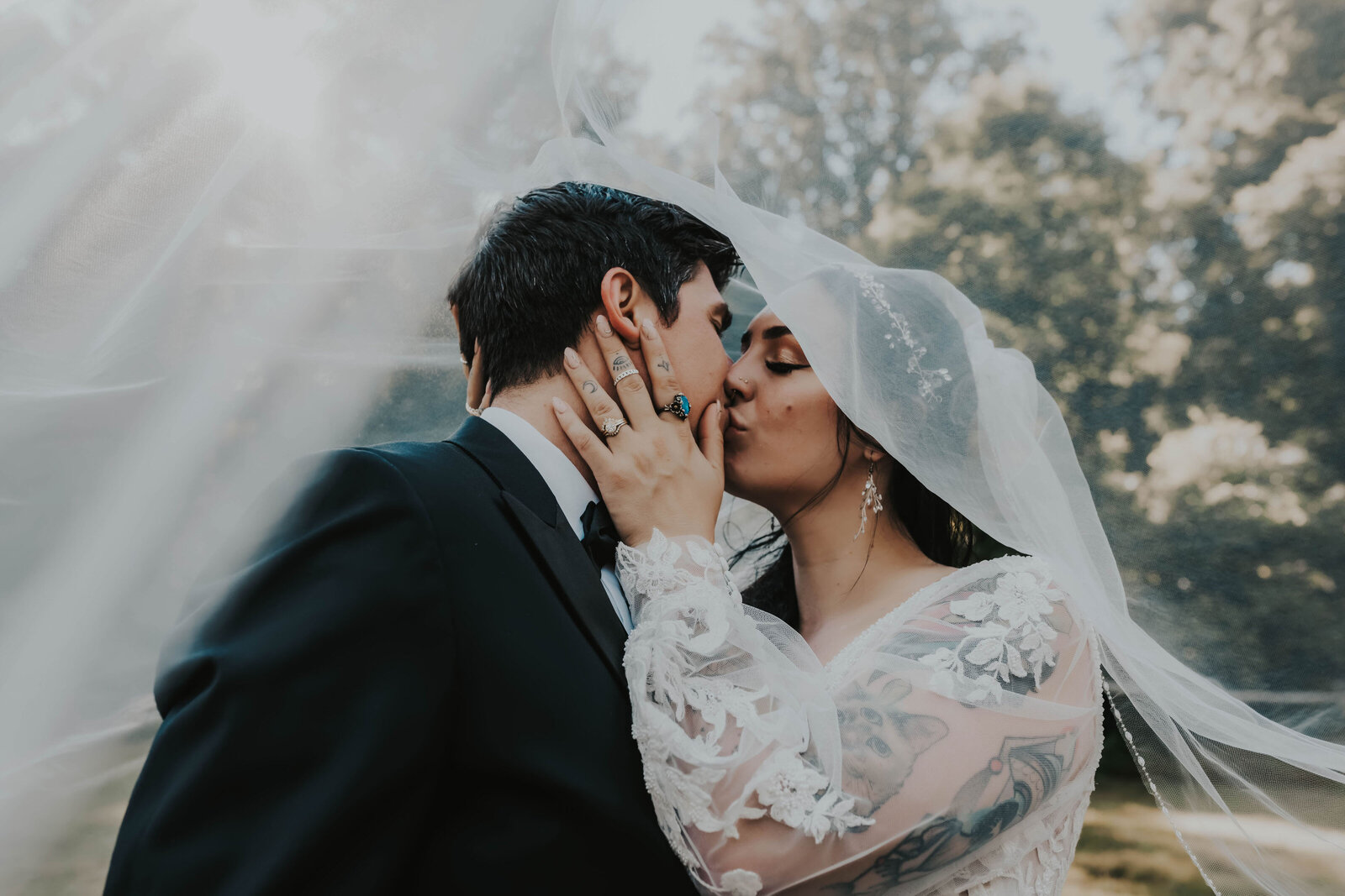newlyweds kiss under veil