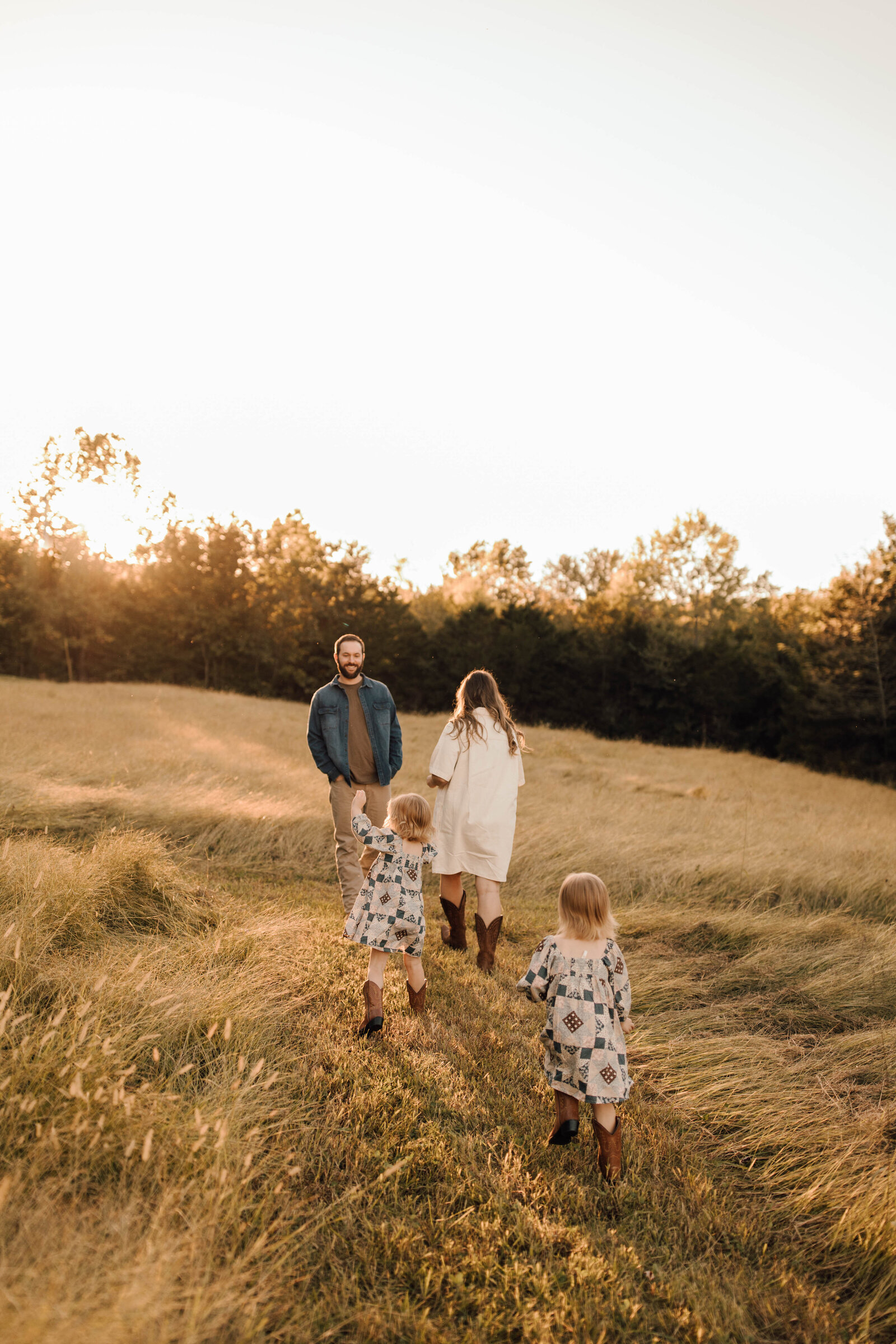 family in a field with twin girls