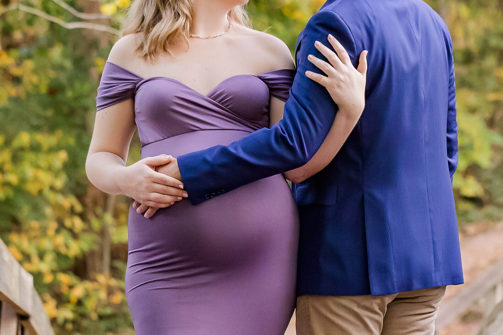 A close-up of a pregnant woman and her husband for their maternity portraits.