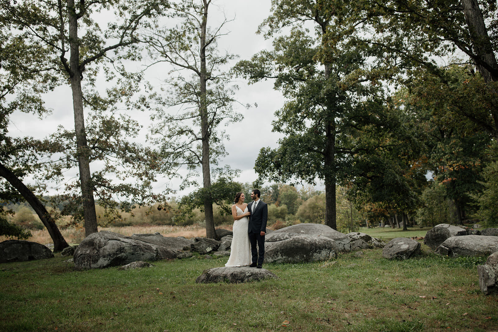 A couple standing in the middle of a Gettysburg Battlefield on their Micro wedding Day