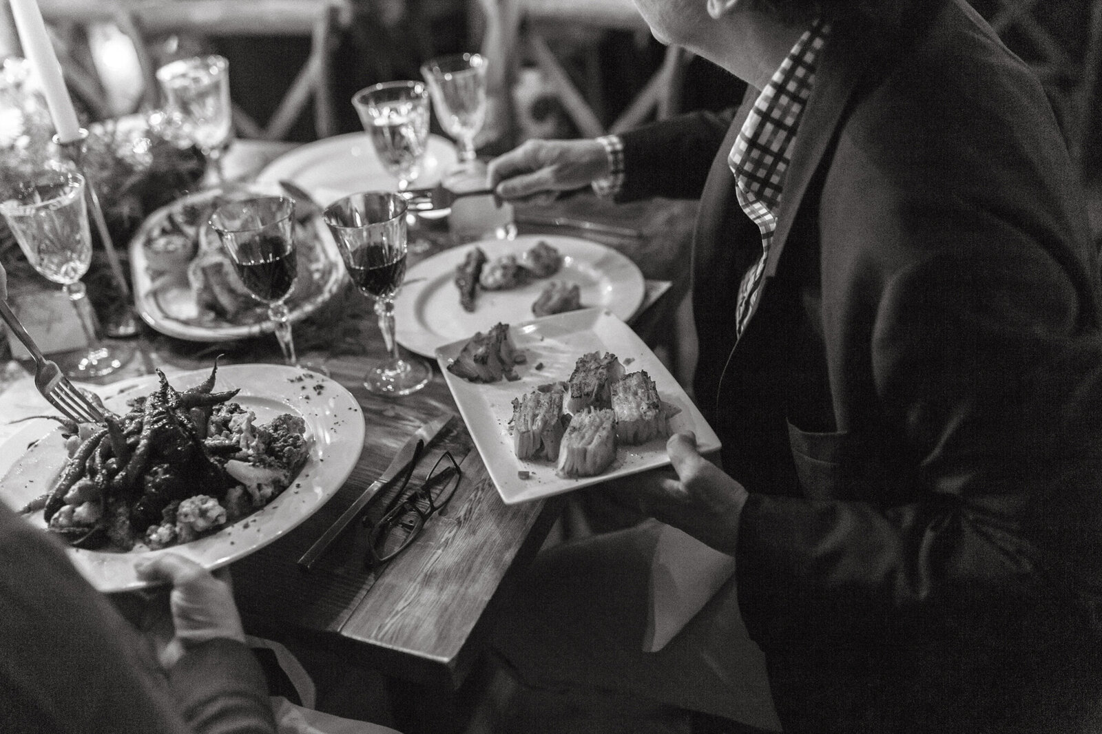 Guest passing family style dinner plate at The Castaway in Portland,