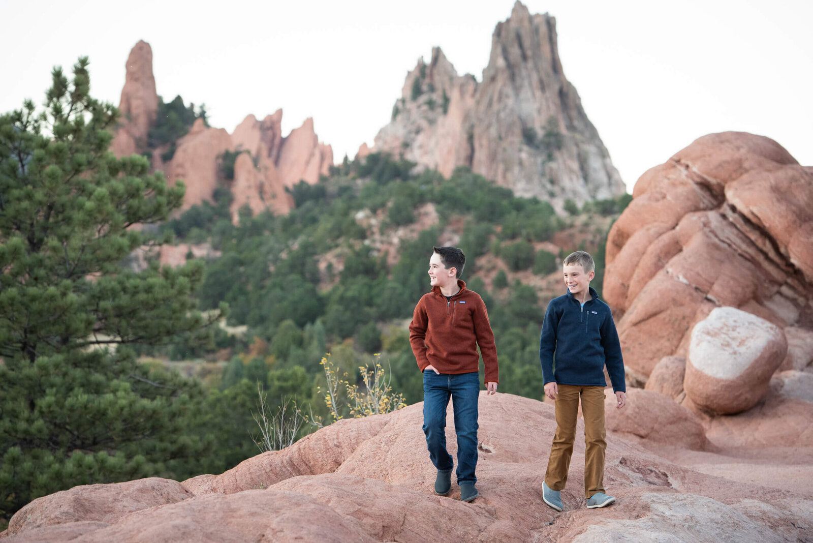 Young brothers hike and explore an orange mountain trail