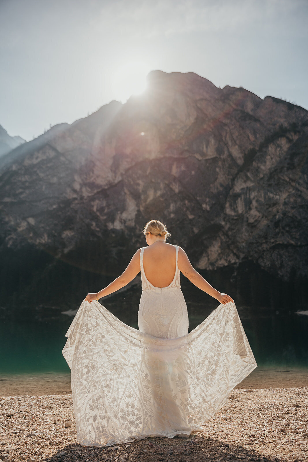 bride poses by lake