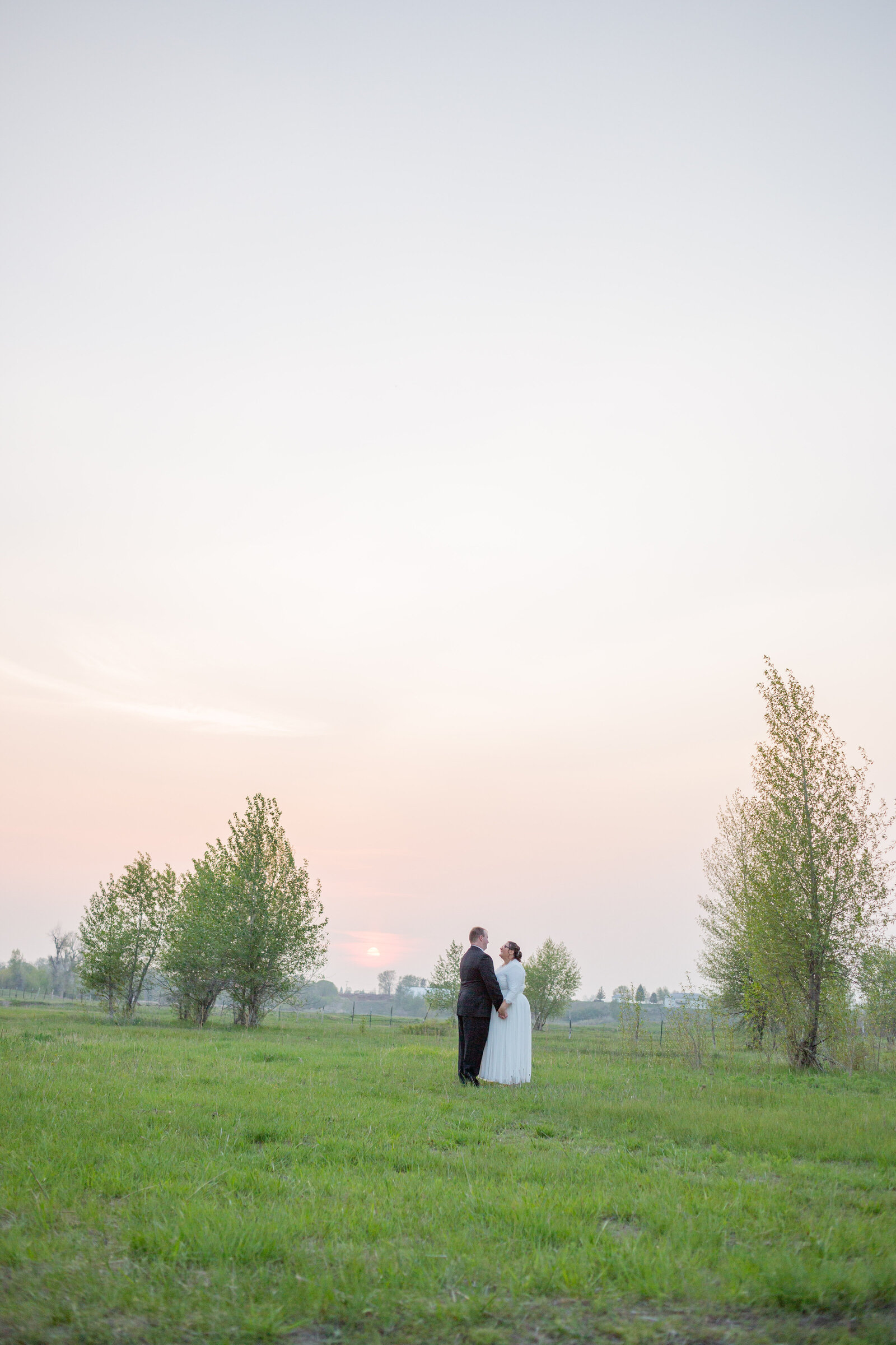 Idaho Wedding Photographer captures spring wedding of couple dancing in field