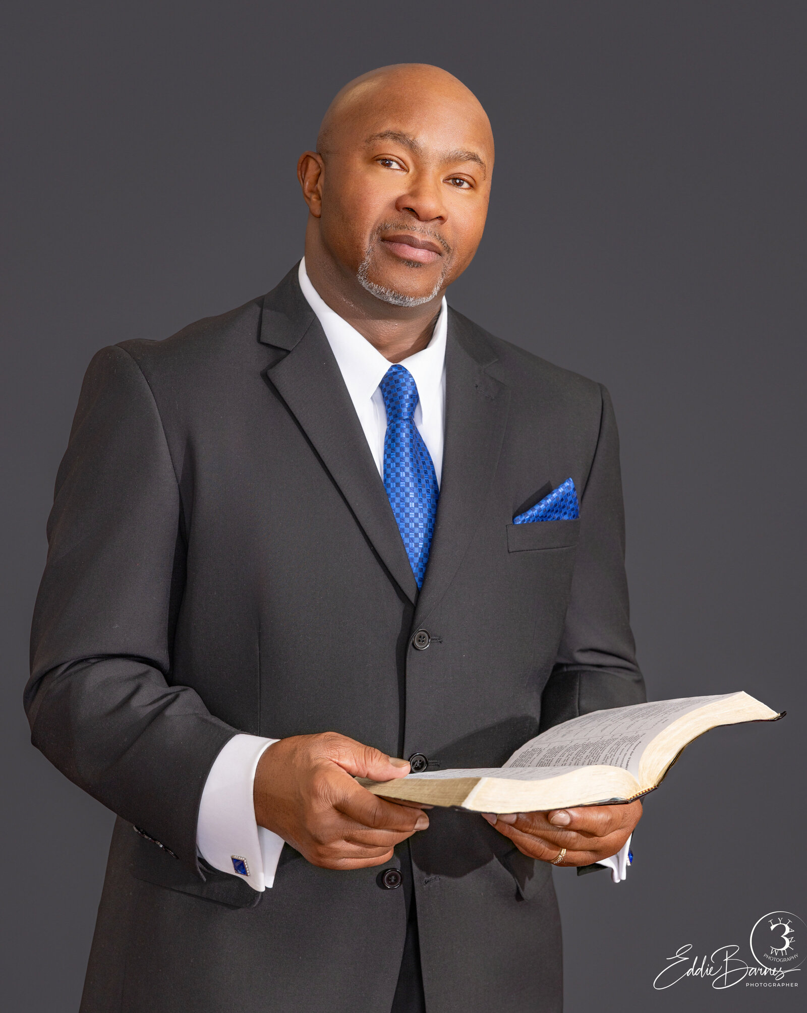 Formal minister portrait with Bible in hand, photographed in Greenville, SC by Tytanium3 Photography.
