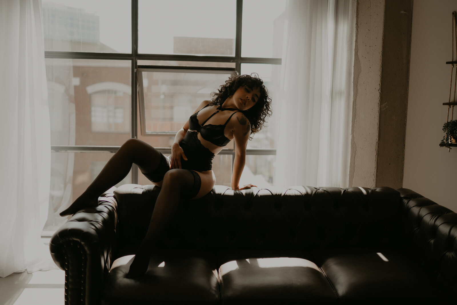 Temecula, California Boudoir photographer Yescphotography girl posing on couch in a dark and moody photo