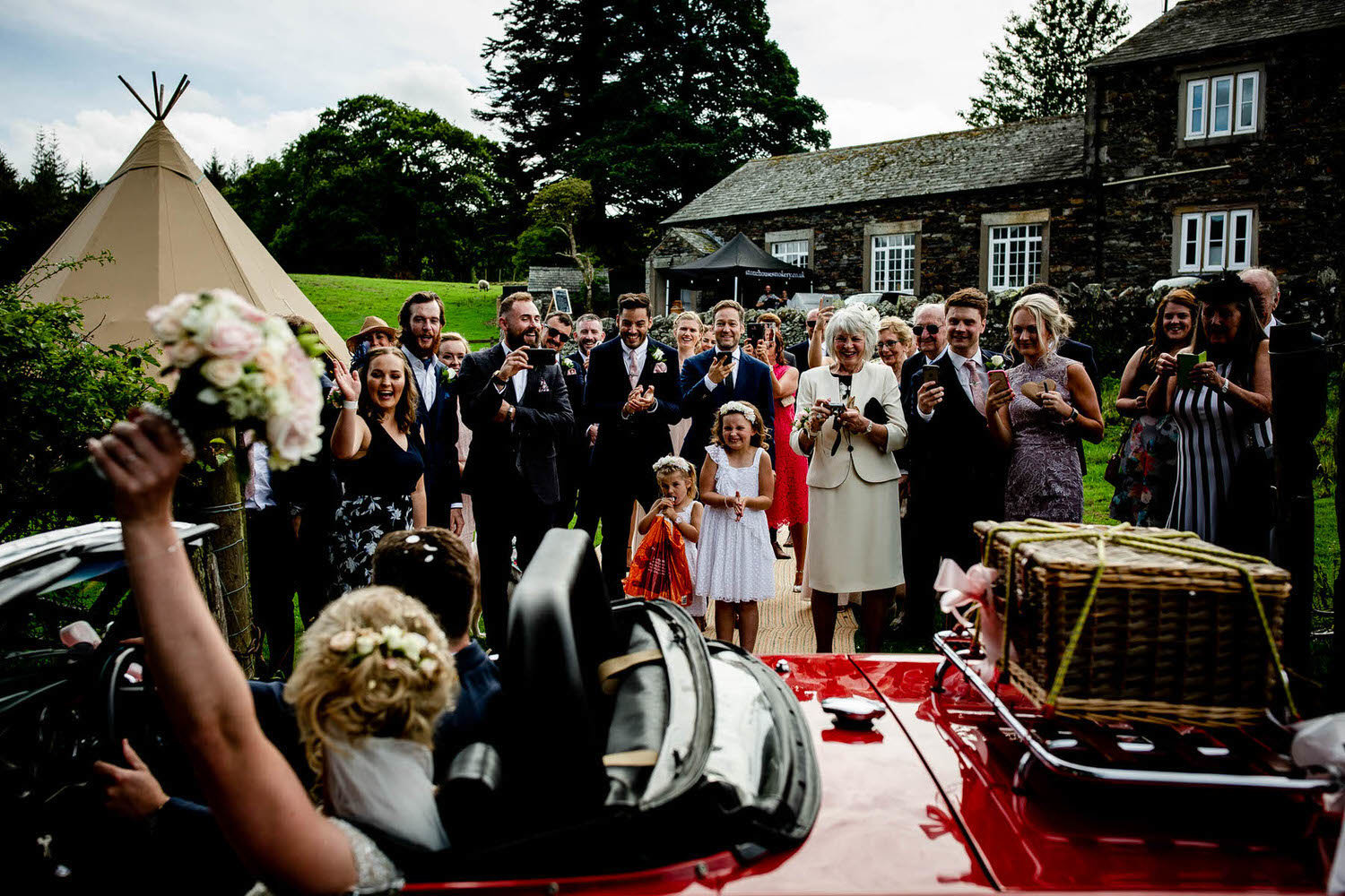 the wedding couple leave in vintage car