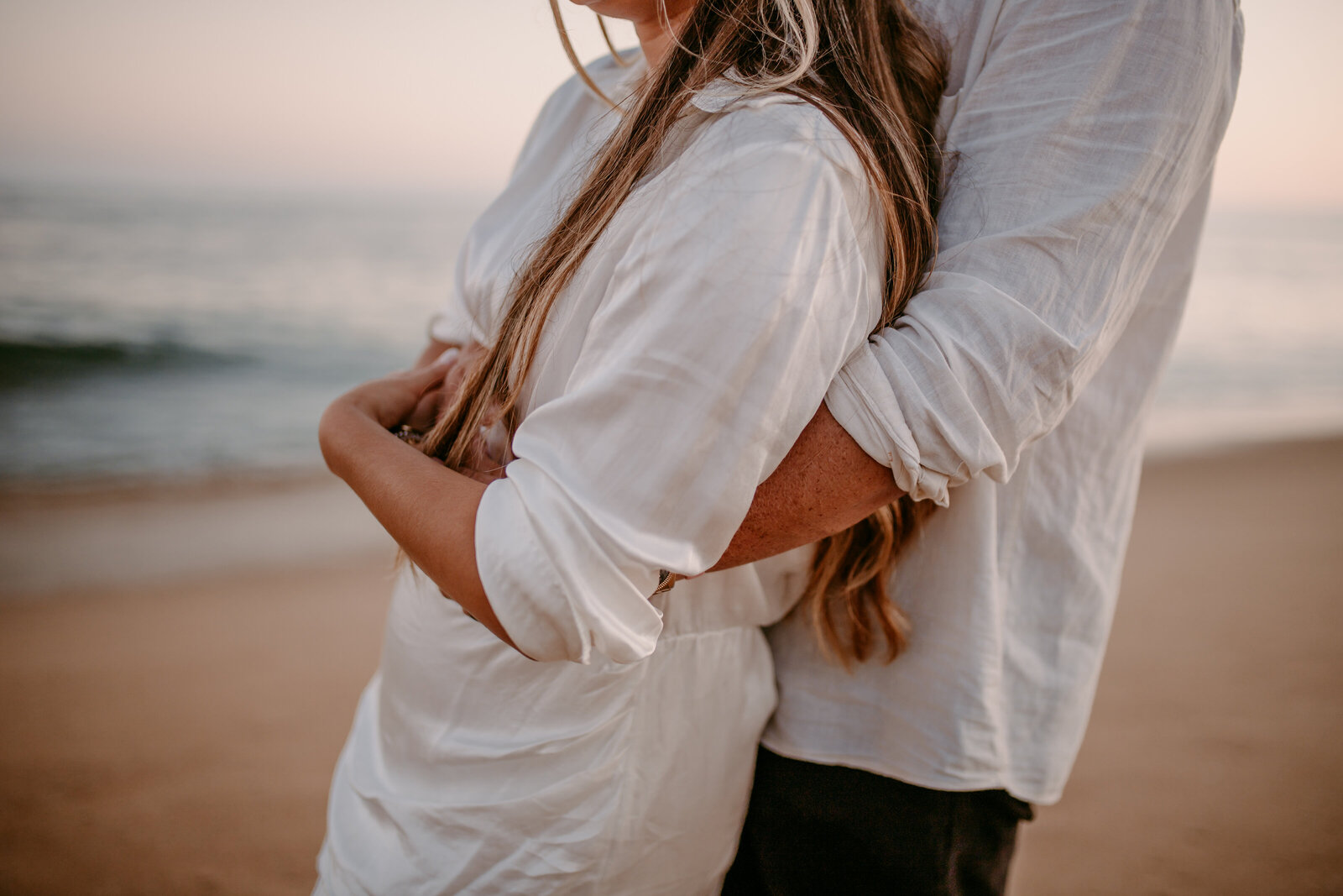 blue hour couple session southern california beach engagement session couple hugging