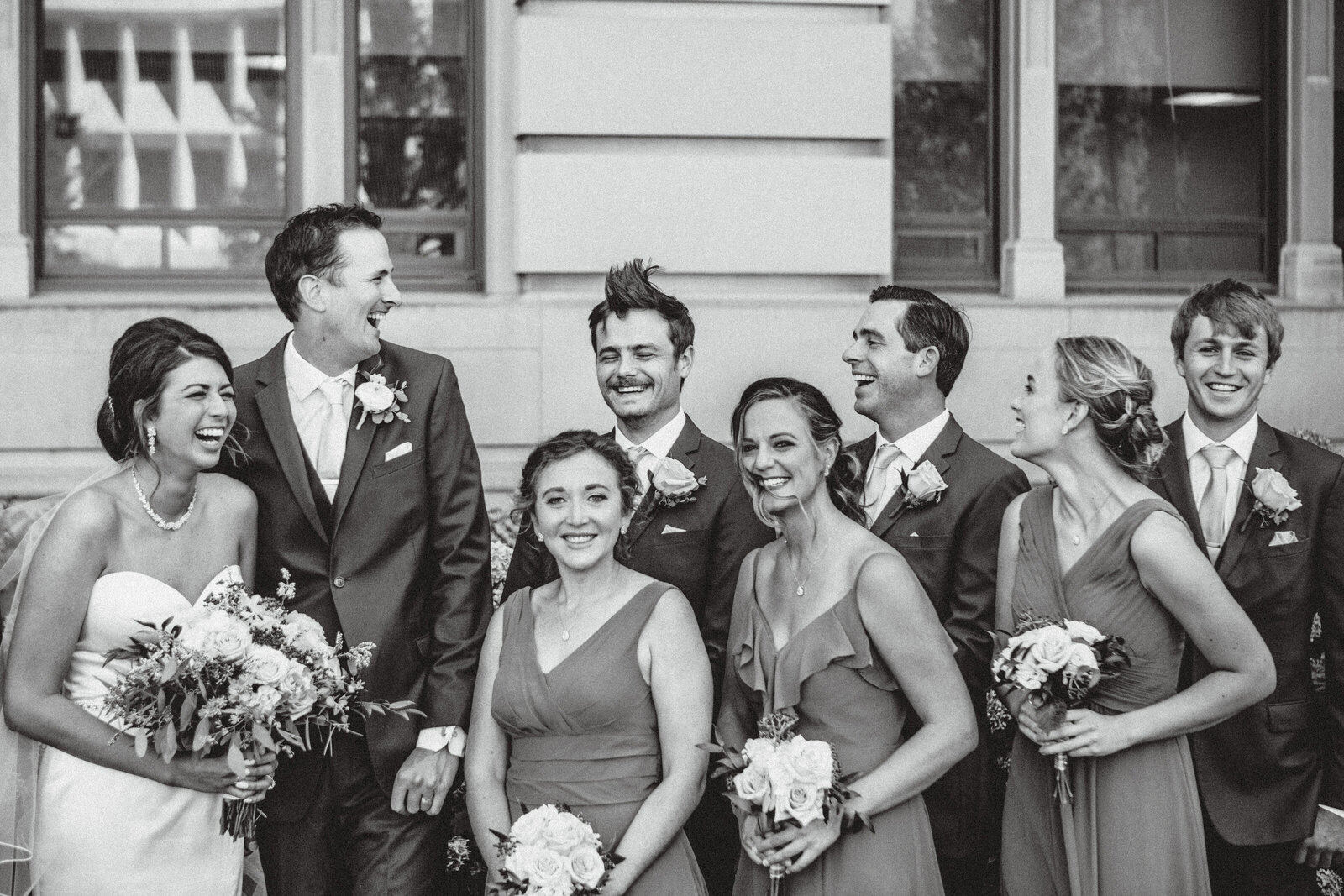 Candid moment of groomsmen hair blowing in wind