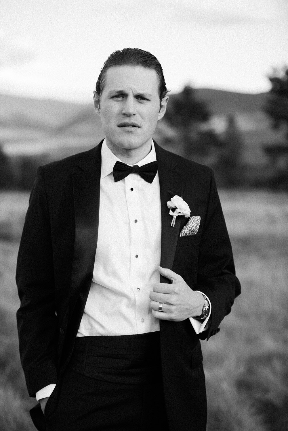 groom portrait serious with hand on lapel