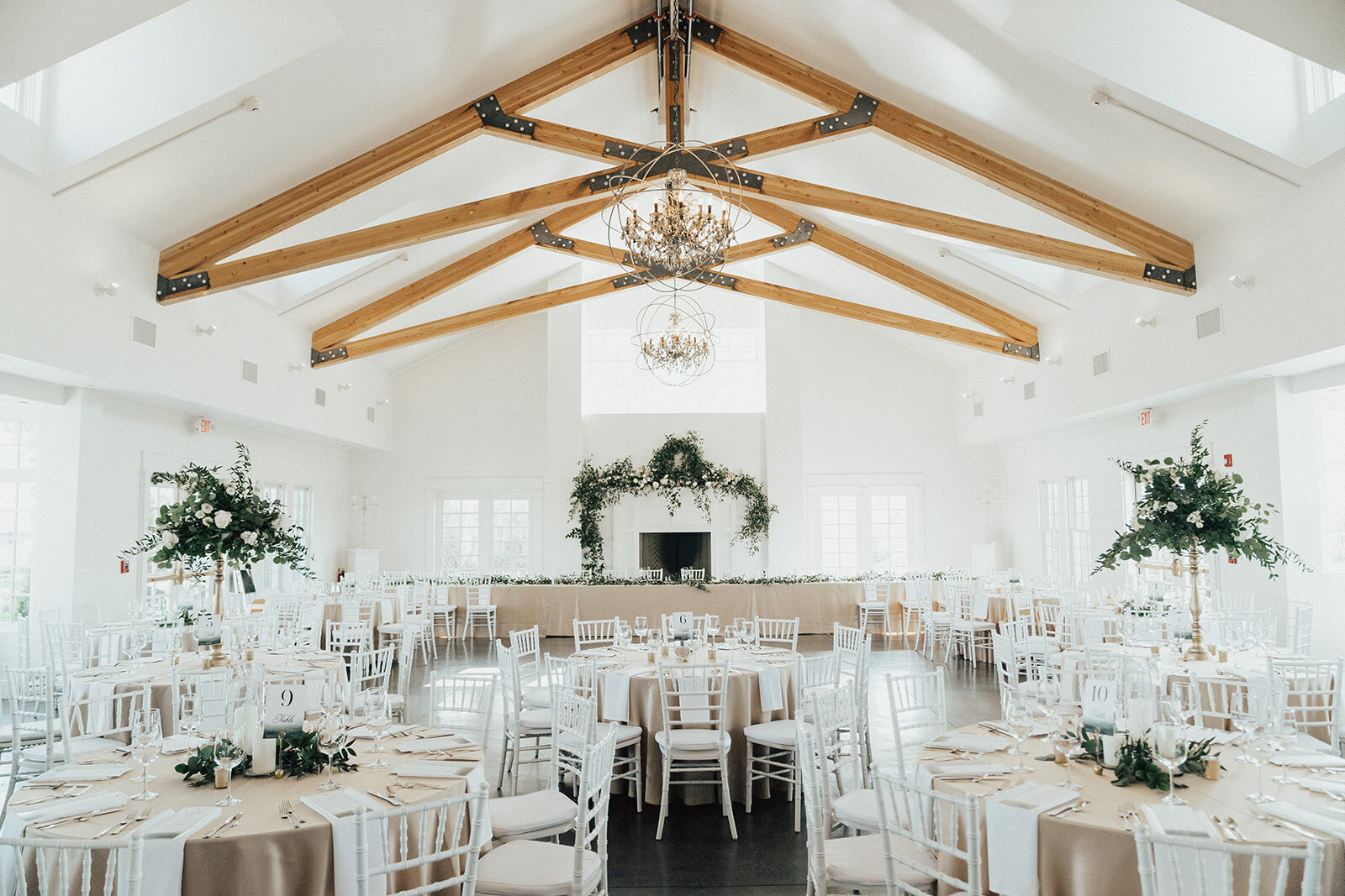 Reception at Manor House with neutral linens and green floral centerpieces