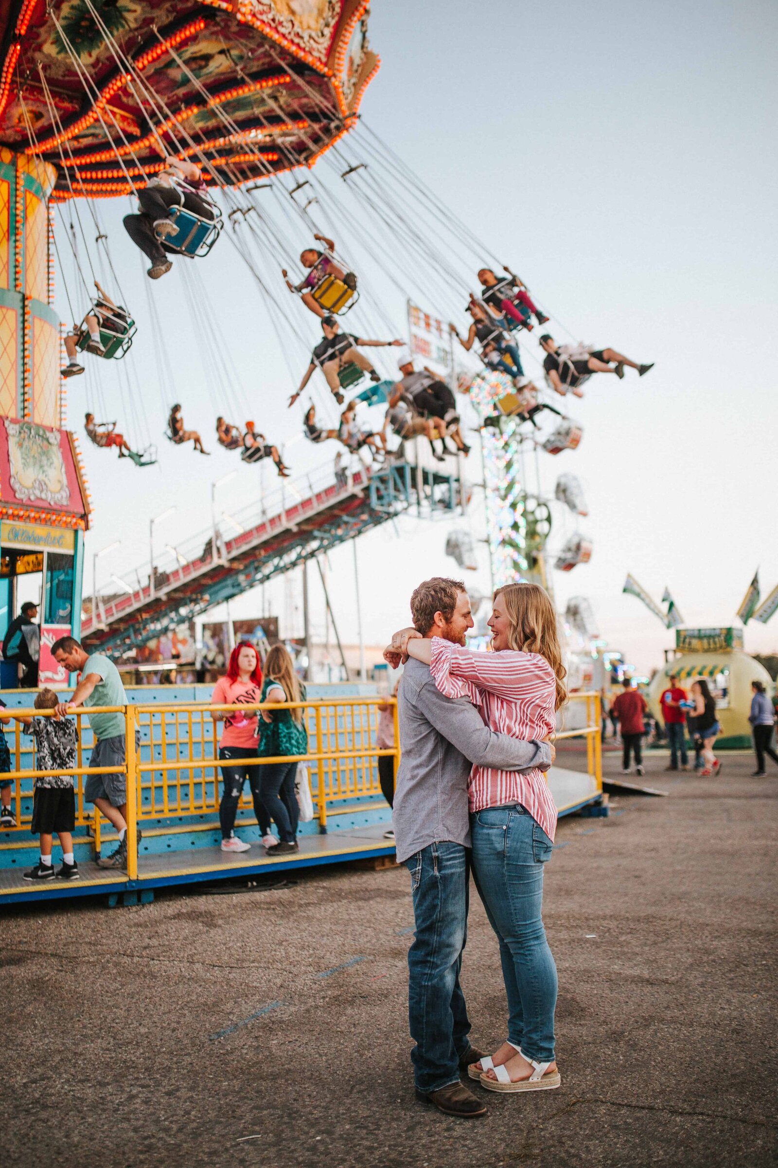 Sacramento Wedding Photographer captures bride and groom hugging at carnival