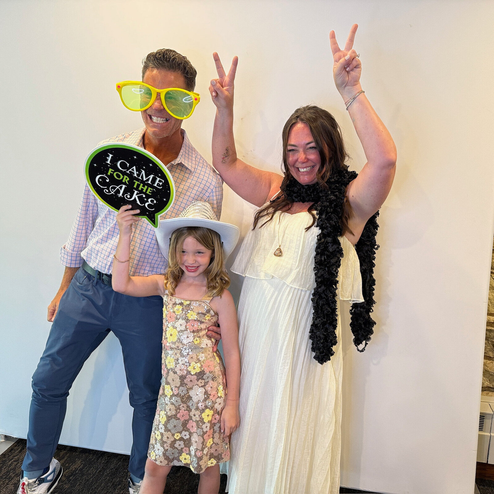 A family in photo booth doing a funny pose