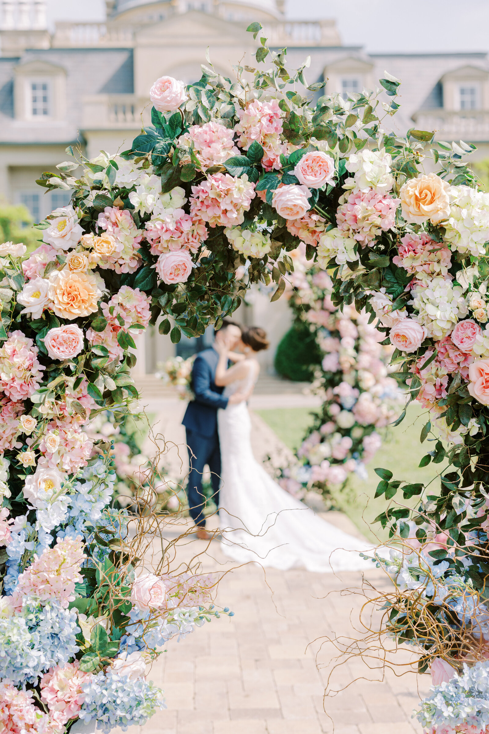 Two floral arches at the Olana in Dallas, Texas with a bride and groom during their wedding portraits