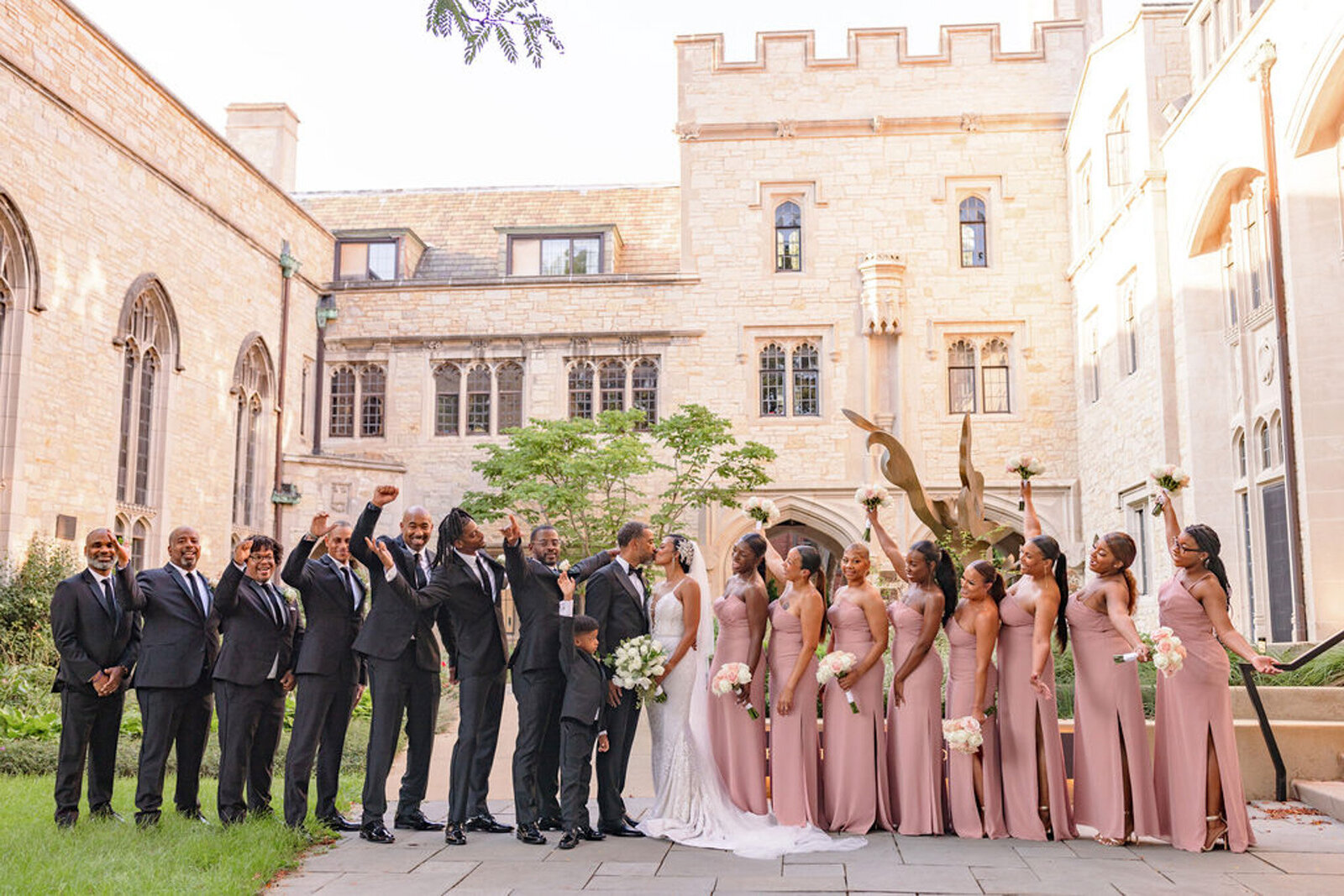 bridal party with charcoal suits and pink dresses