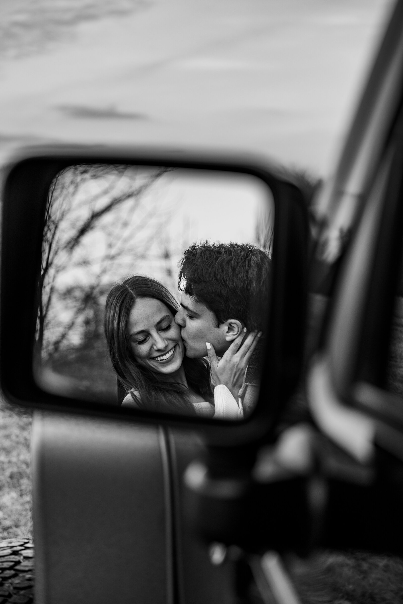 Black and white shot of Nolan kissing Cecilia, 