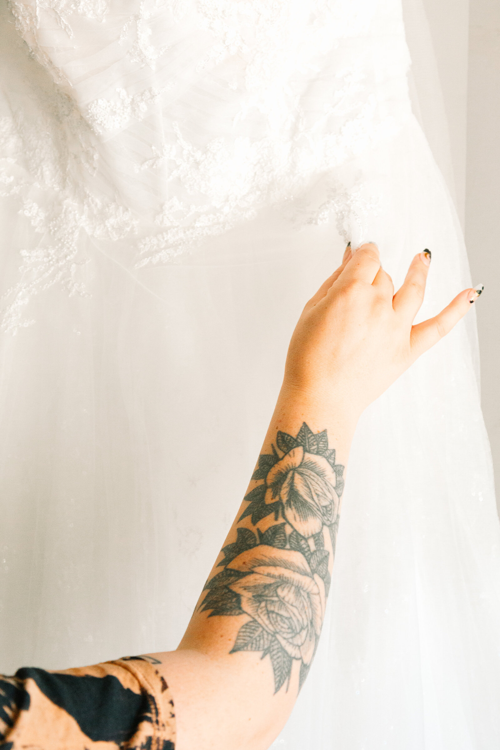 A bride with red hair and tattoos gets ready on her wedding day.