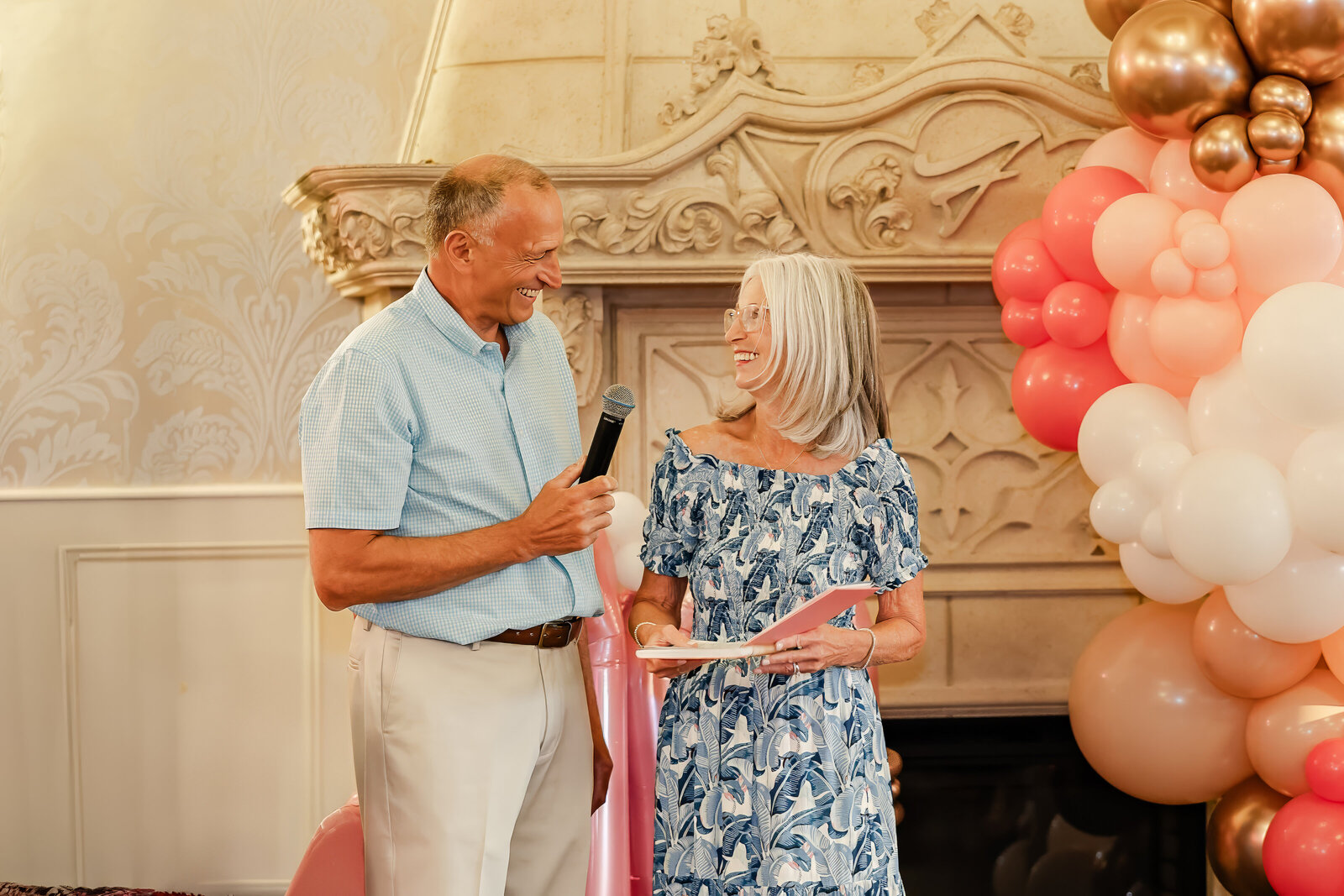 Couple looks at each other during a birthday speech.
