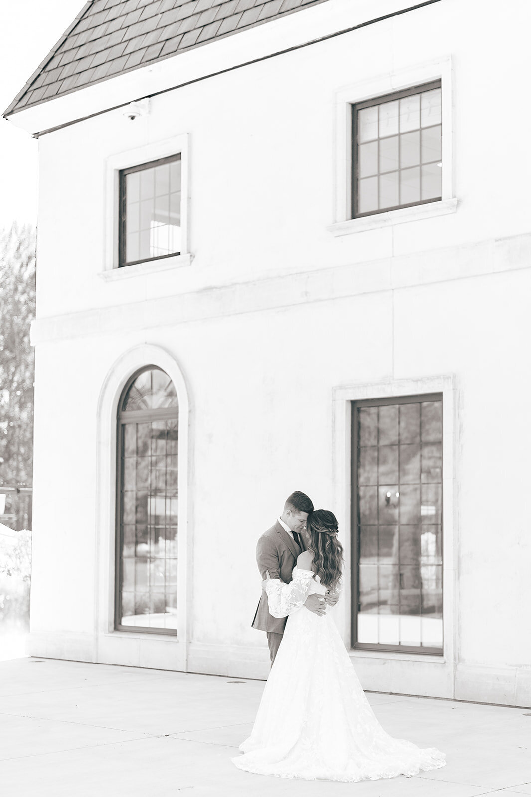 Bridal and groom portraits outside white building at the Chateau Des Fleurs Wedding in Boise idaho