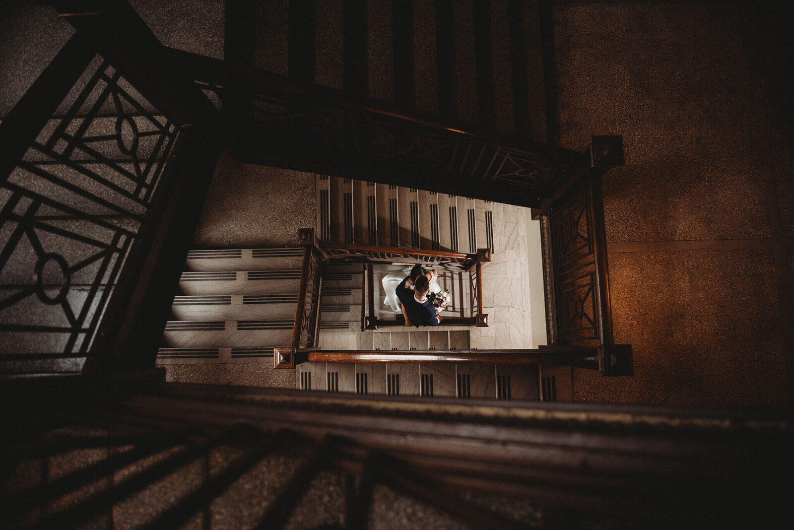 bride and groom in stairwell at Greystone Hall Wedding Reception