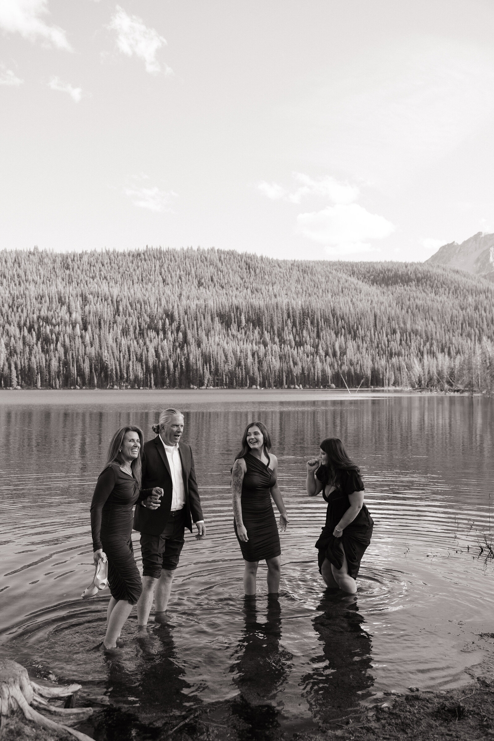 Wedding guests playing together in Stanley Lake during intimate wedding reception in Idaho