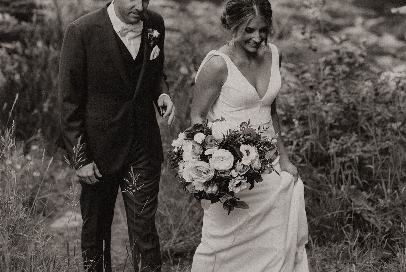 Black and white photo of married couple walking happily