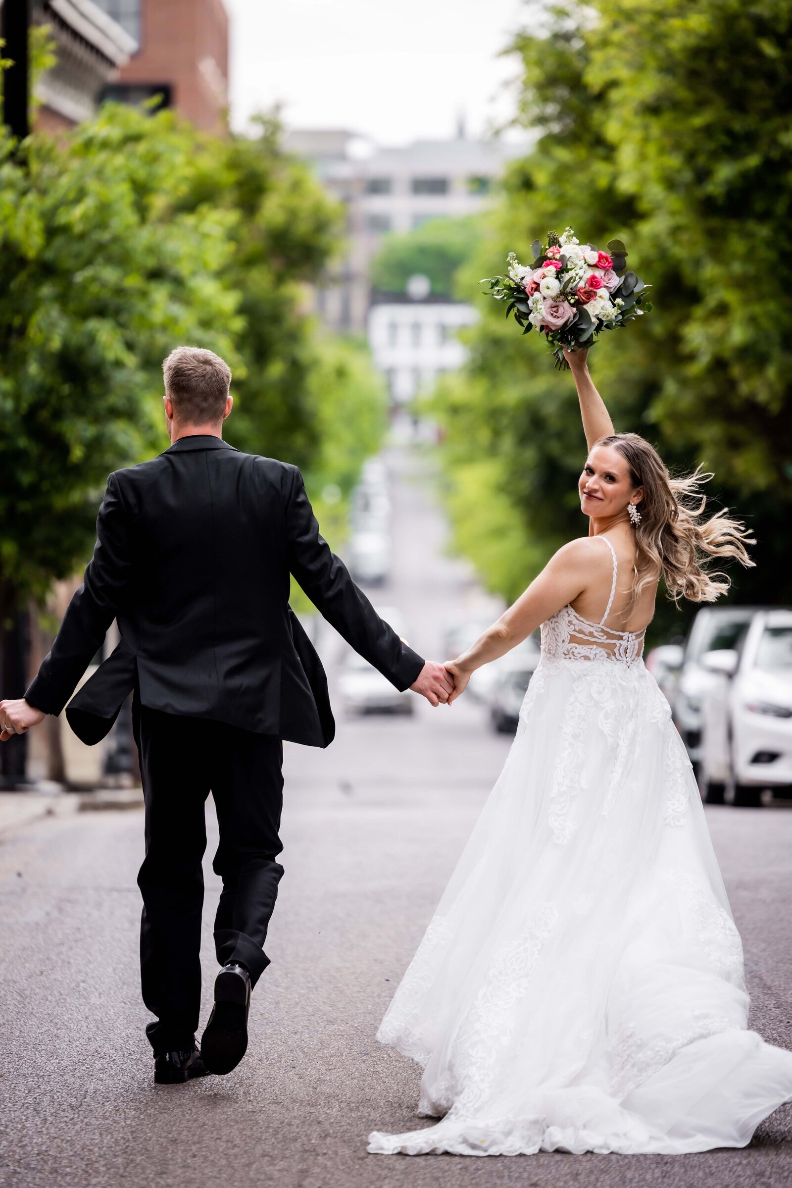 Capture the joyous moment with Sandy and Jack as they take their first walk as a married couple, blissfully strolling through the streets. This stunning photograph embodies the happiness and love of their special day, offering a glimpse into their magical wedding journey. Perfect for couples seeking inspiration for capturing their own memorable moments.