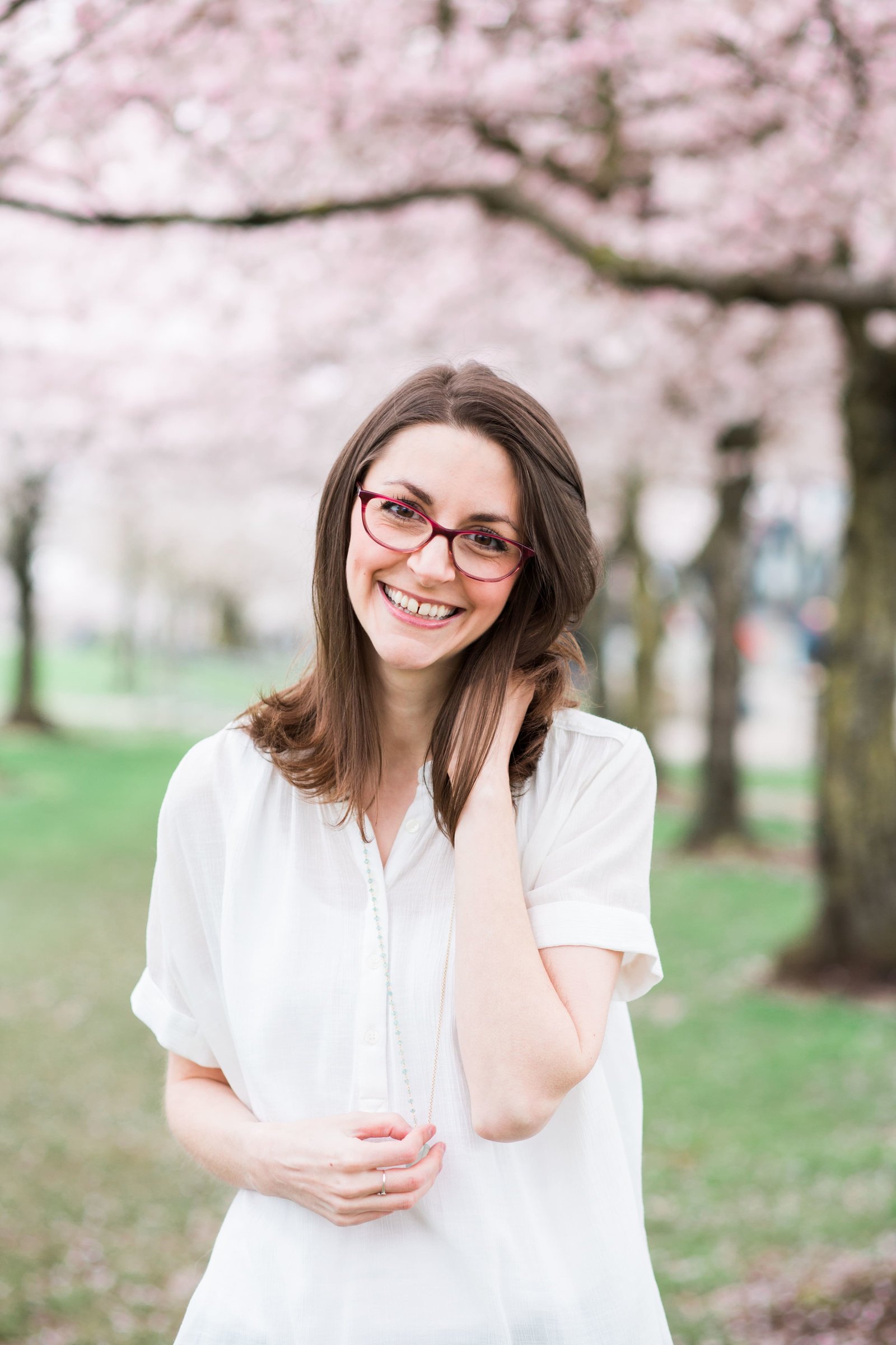 Personal brand photography with cherry blossoms at Portland waterfront