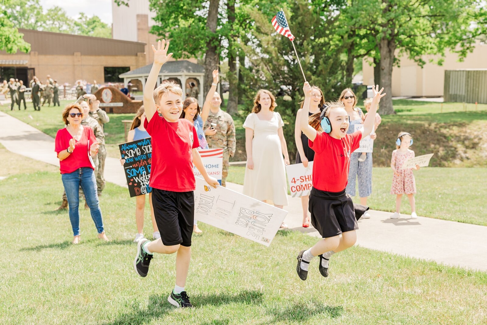 Excited kids jumping during a military homecoming