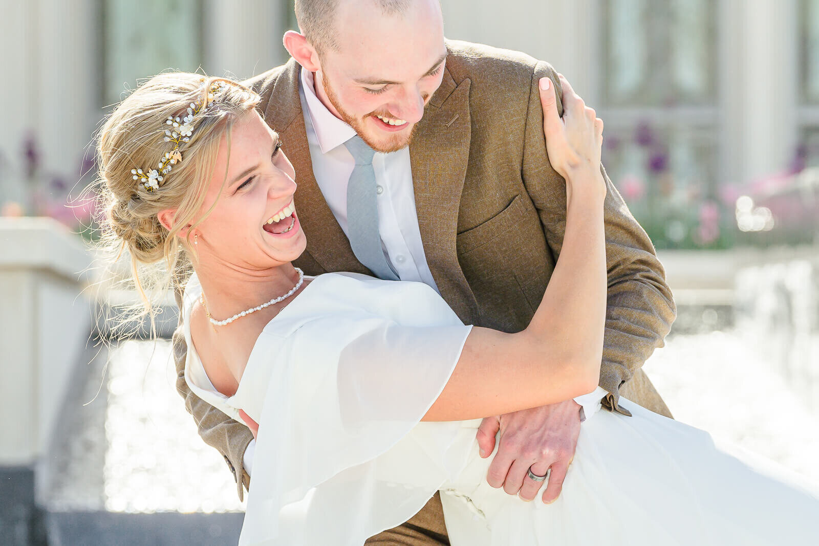 Utah bride and groom laughing after their spring wedding. Captured at the payson temple.