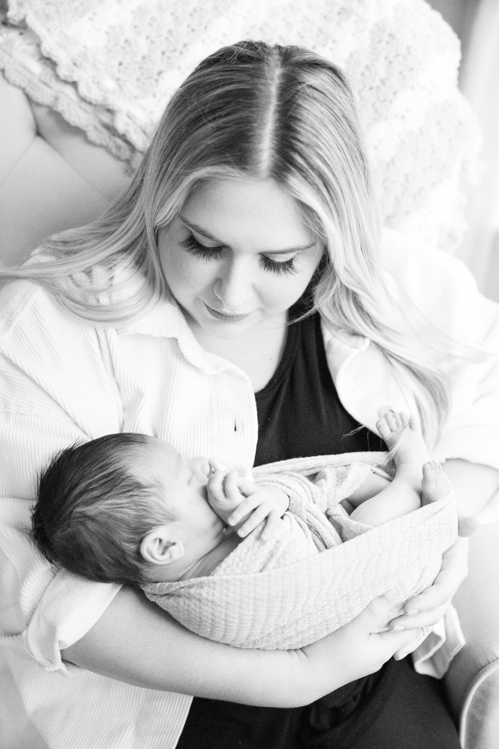 Lifestyle Newborn Photographer Akron Ohio timeless black and white image mother and swaddled baby boy