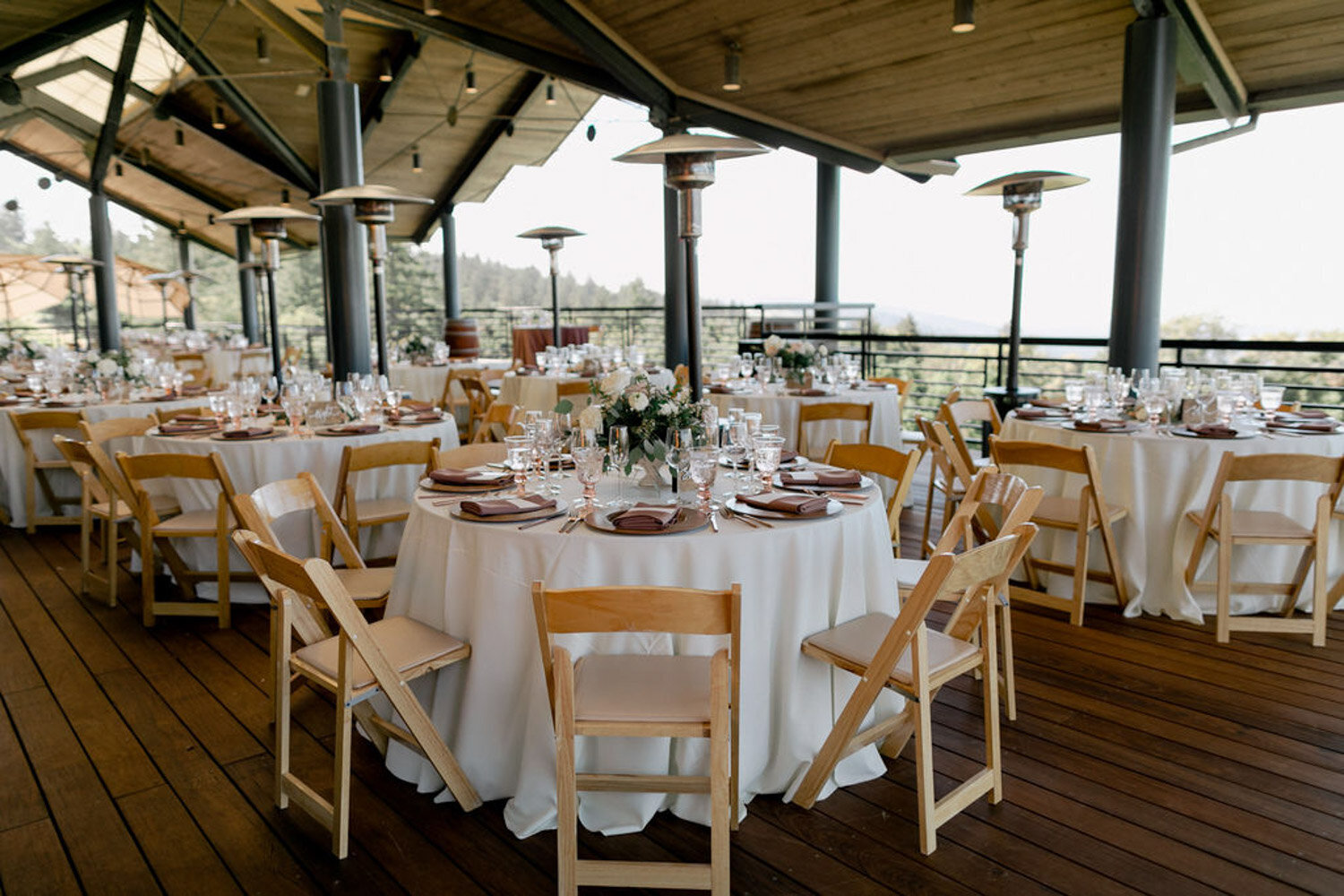 Wedding dining table with white cloth and brown chairs