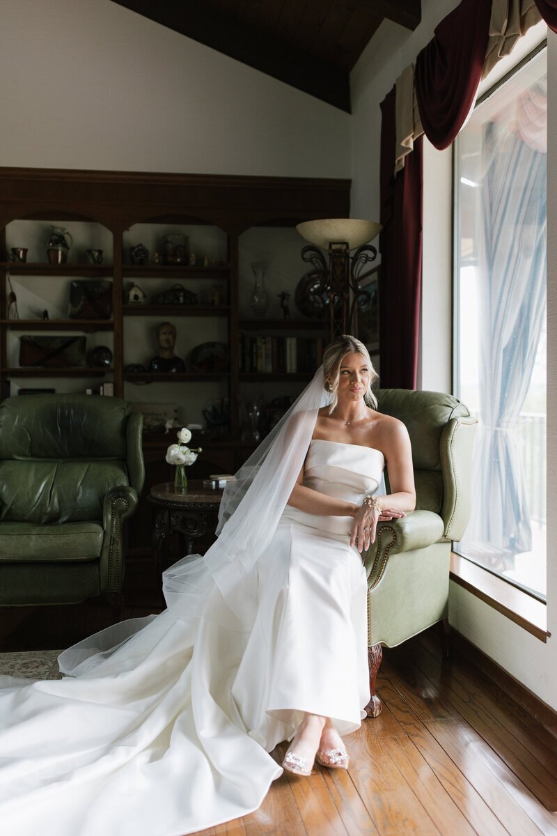 Bride looking out window by Erica Rochelle elopement photographer washington state