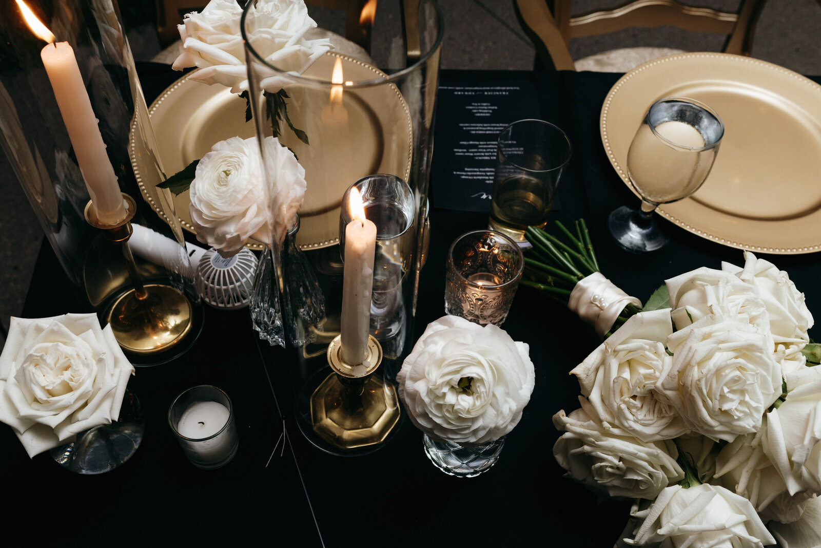 Tablescape of black and white luxury wedding with gold plates and glass tableware | Emma LeeAnn Photography