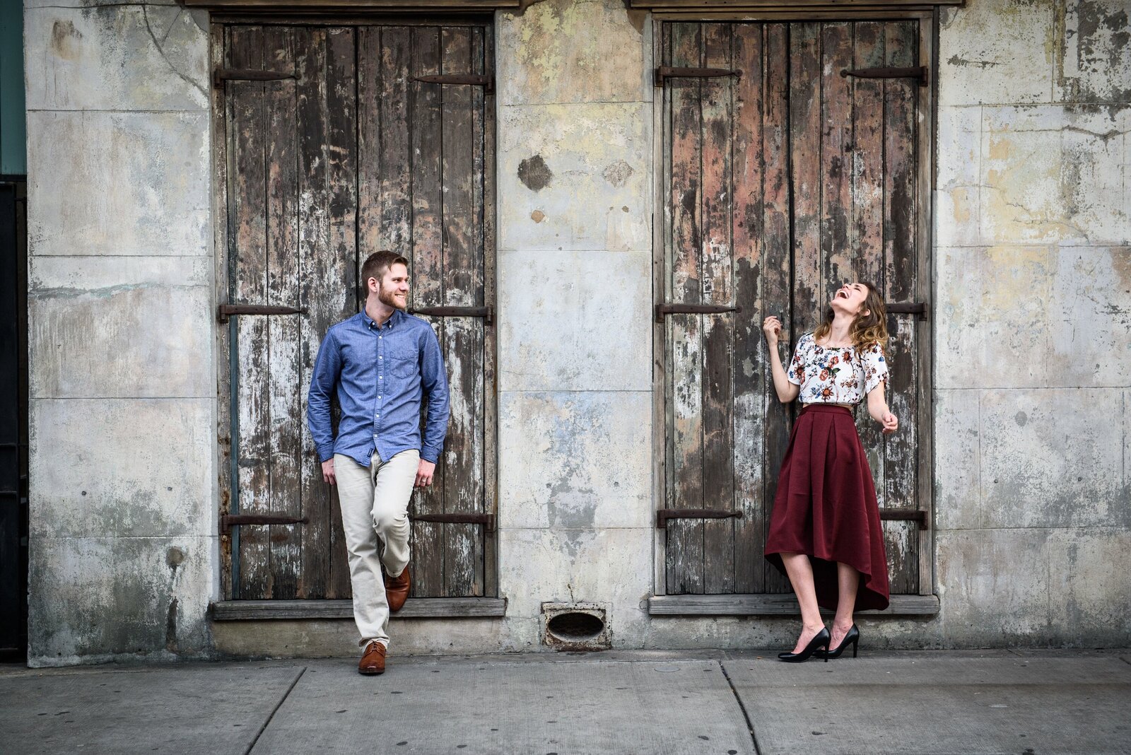 Couple standing in front of weathered doors in the French Quarter